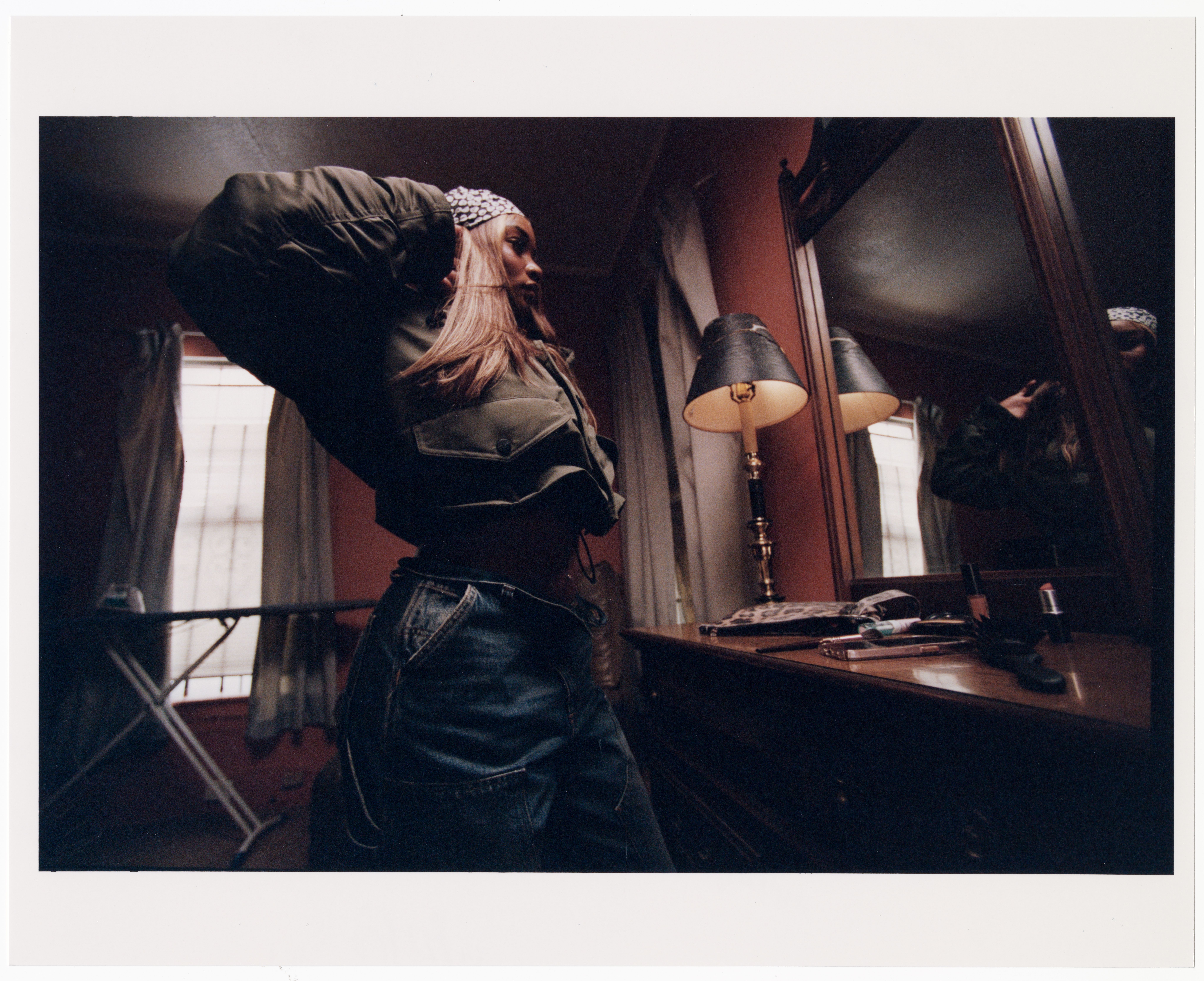 Model posing in front of a mirror wearing Carhartt WIP items in the Fall 2025 Campaign shot by Dan Regan