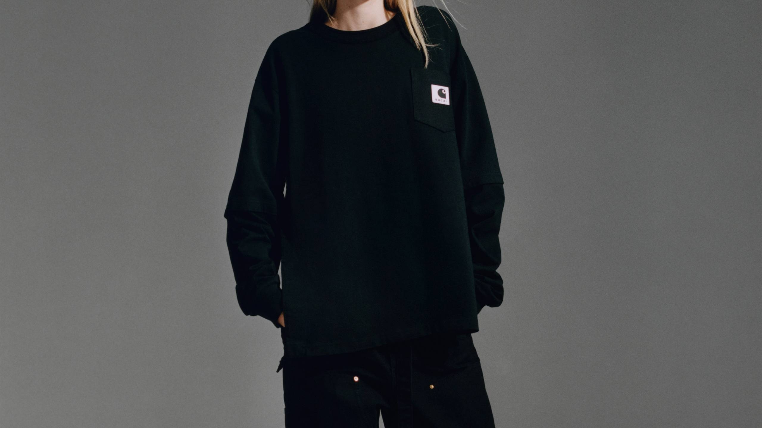 Model wearing a longsleeve sacai x Carhartt WIP shirt