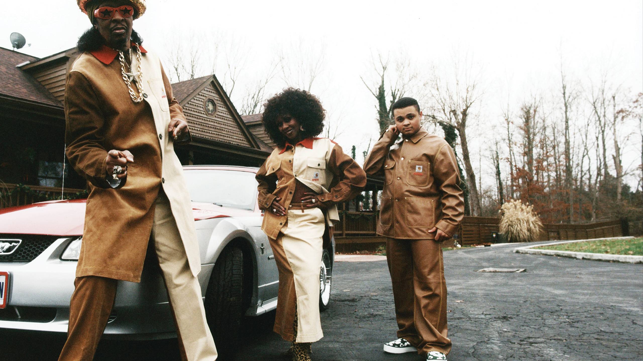 3 Models wearing MARNI x Carhartt WIP next to a car