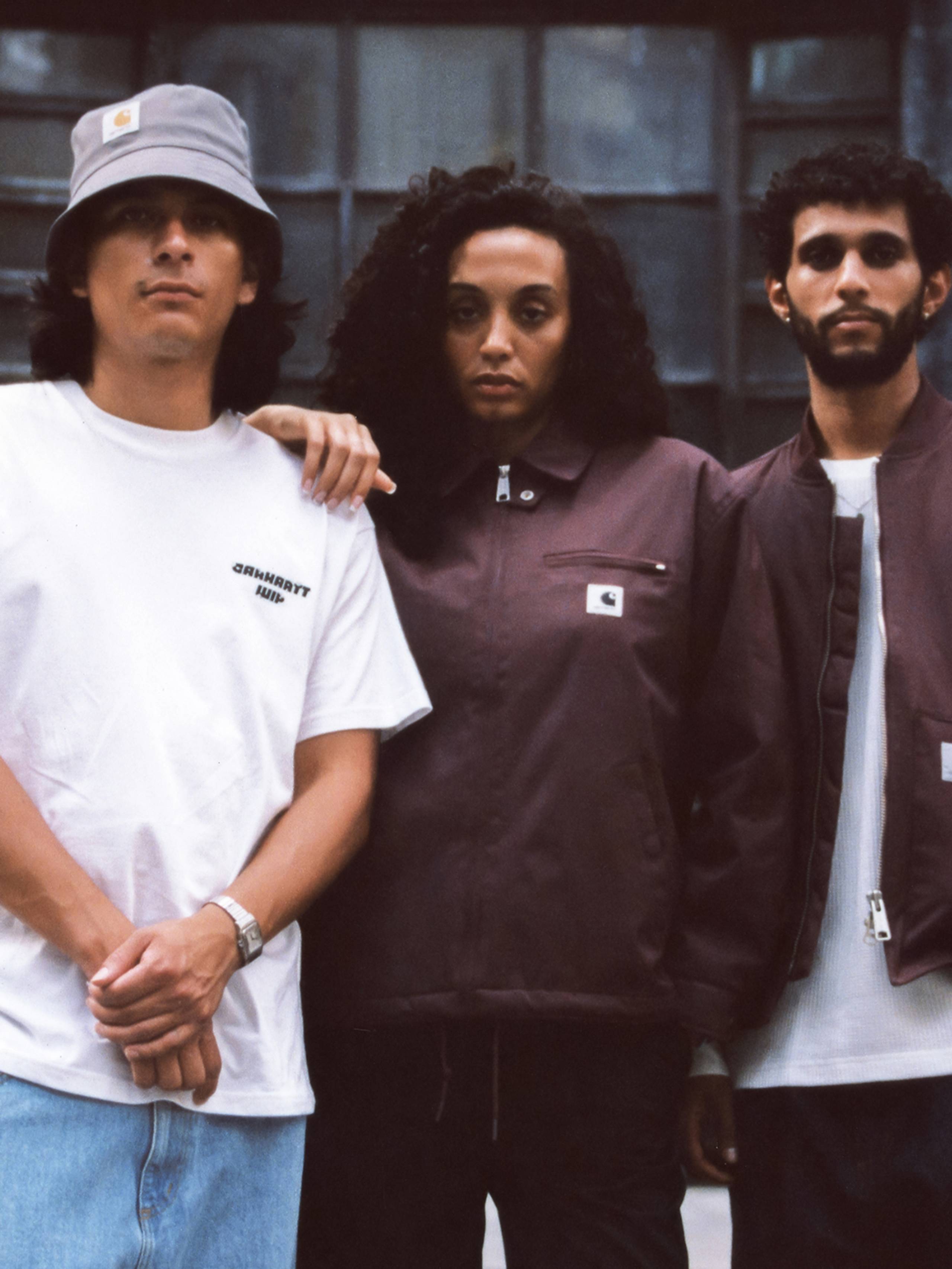 Group shot of models standing in front of city building wearing items from the Carhartt WIP Wiptopia Collection