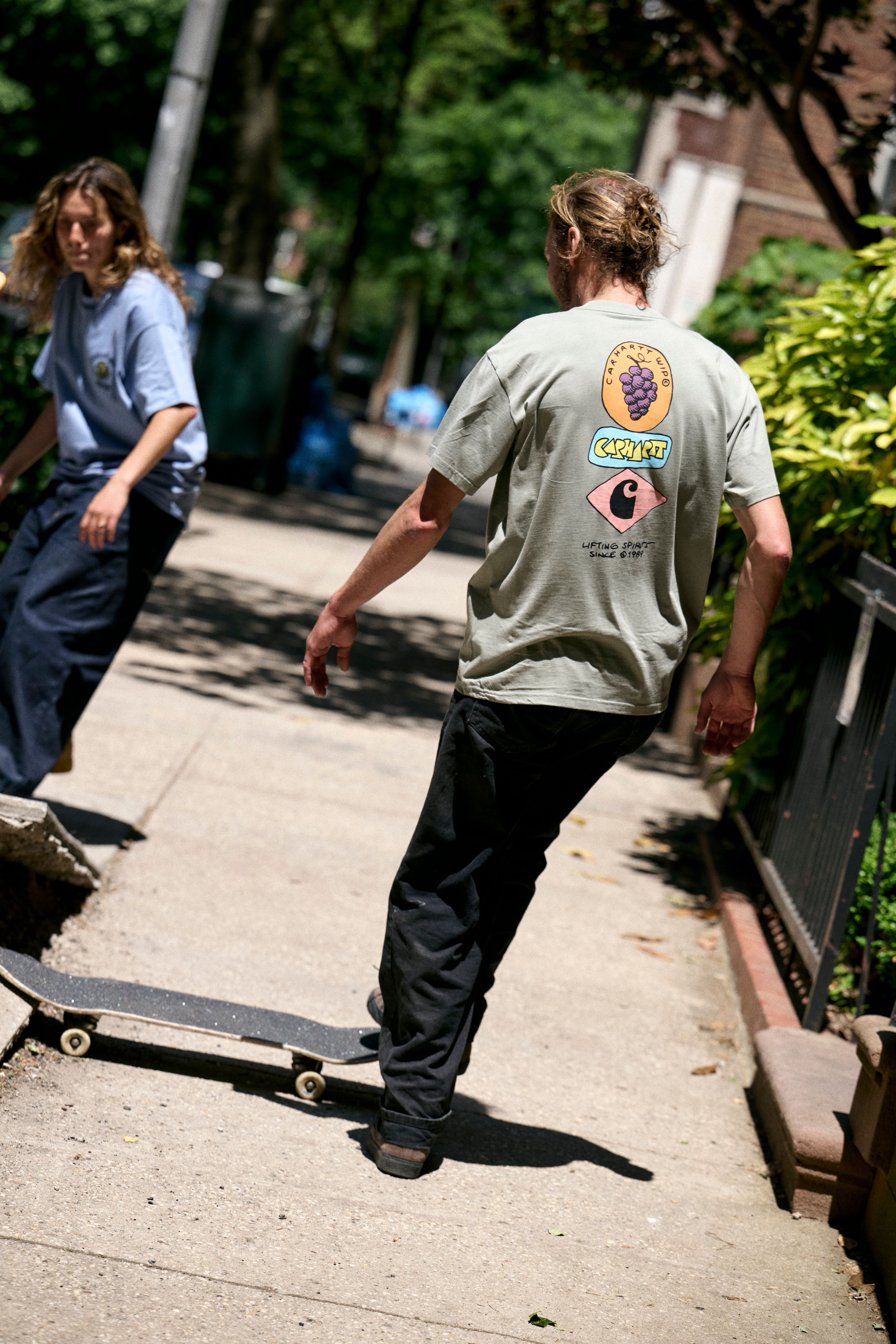 Model wearing a Stacked Grapes T-Shirt in Shady Green