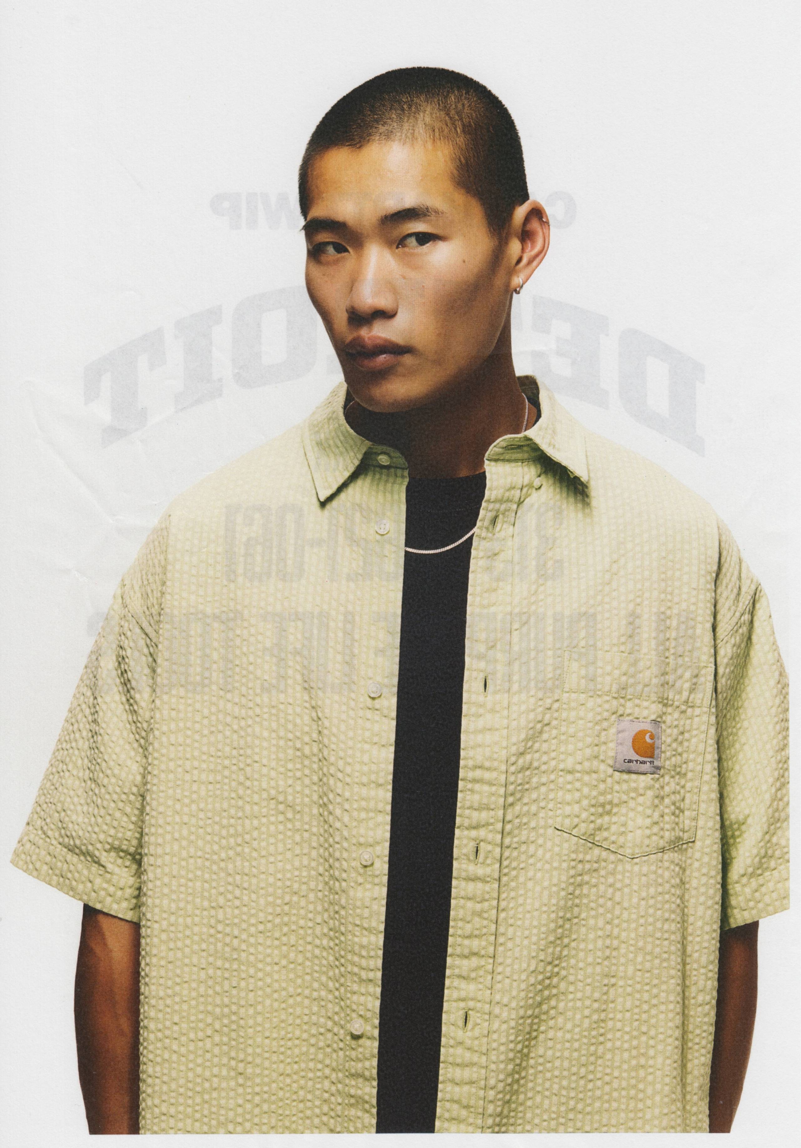 Model wearing a pair of Carhartt WIP Toland Shirt in Pale Olive