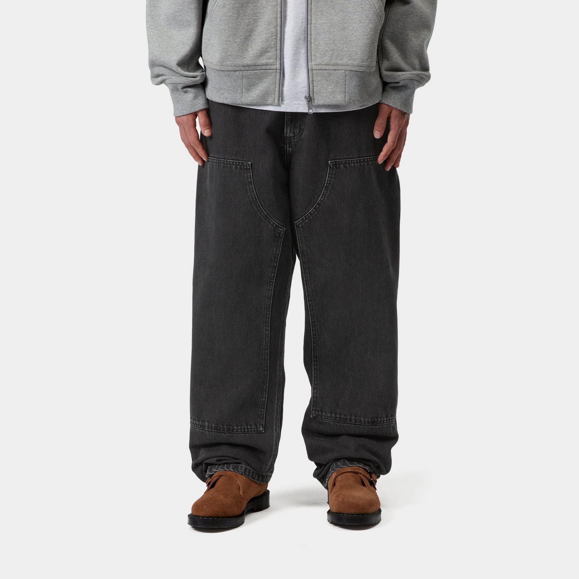 Model wearing a pair of Double Knee Pants in Black Stone Wash