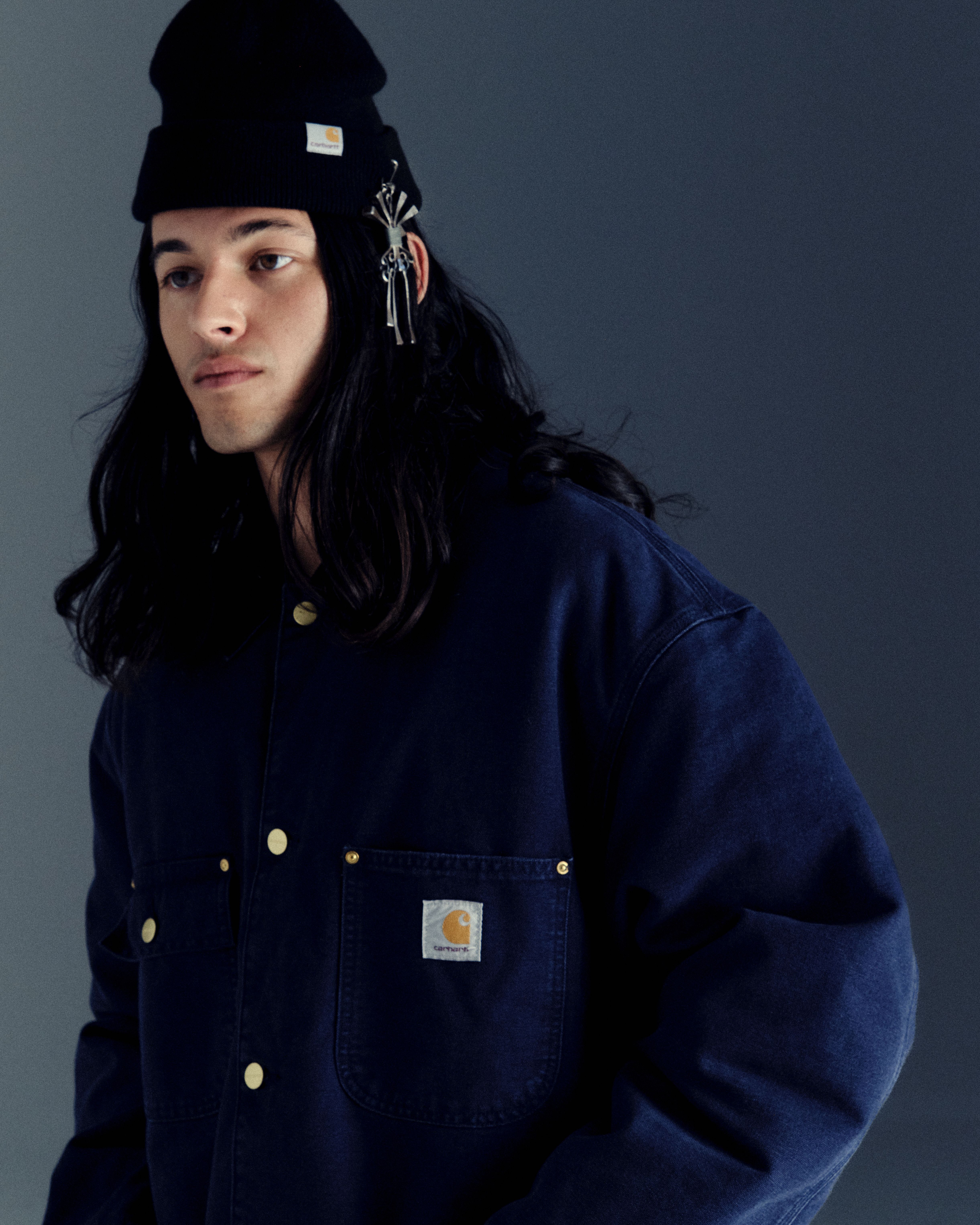 Model wearing a Michigan Chore Coat in Dark Navy in Carhartt WIP Icons Revisited shoot