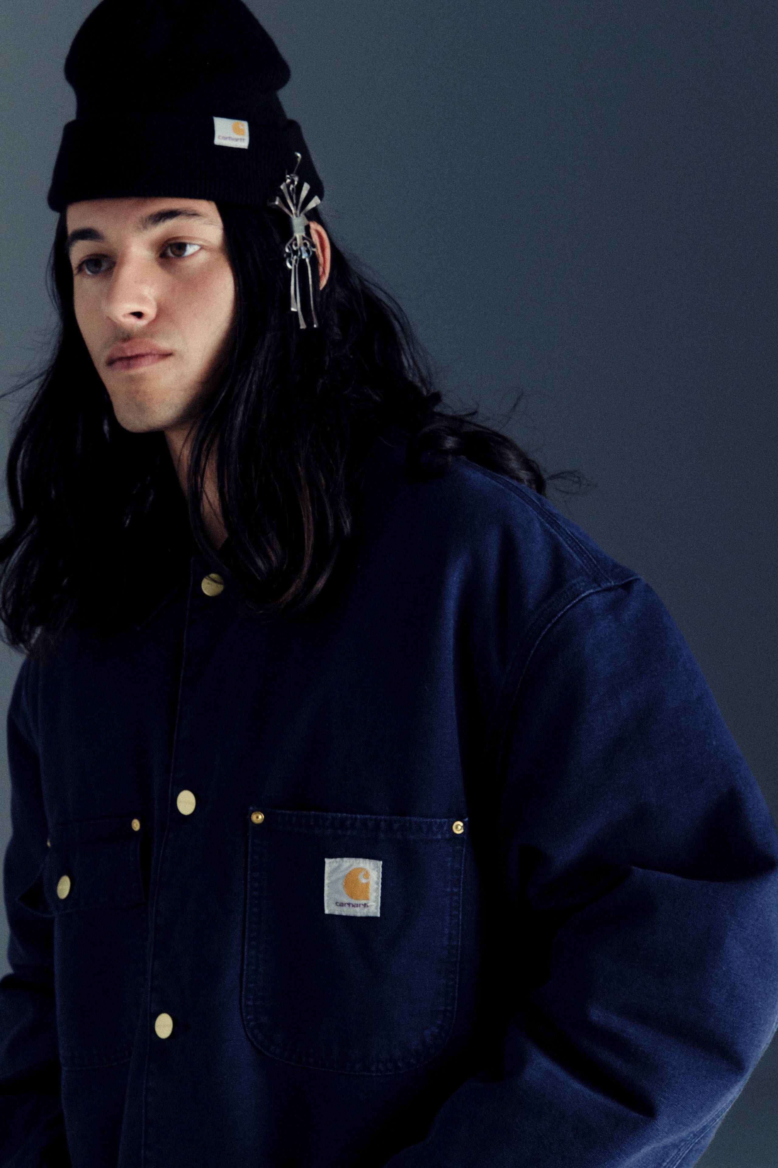 Model wearing a Michigan Chore Coat in Dark Navy in Carhartt WIP Icons Revisited shoot