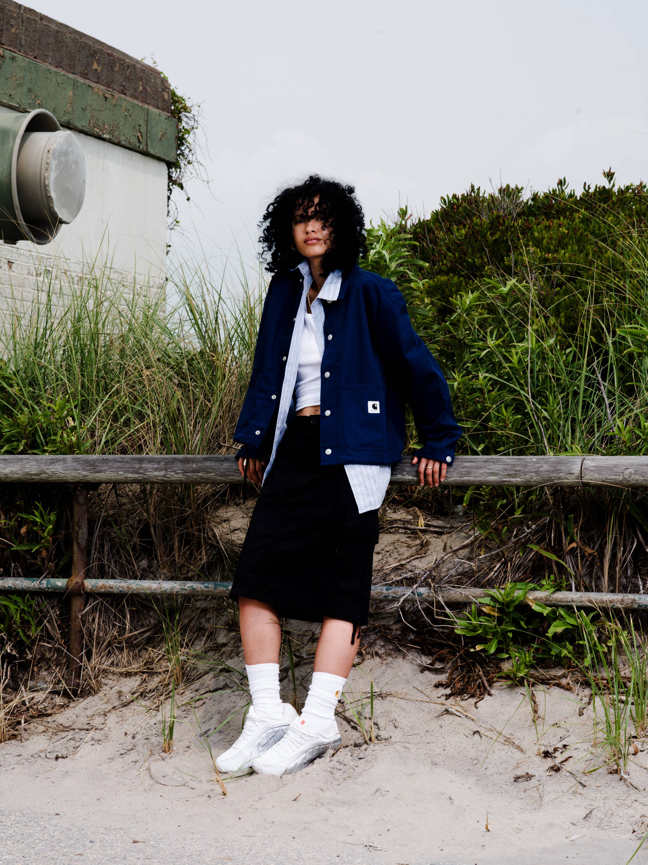 Model wearing a Women’s Simple Shirt Jacket in Jupiter and Kingston Skirt in Black