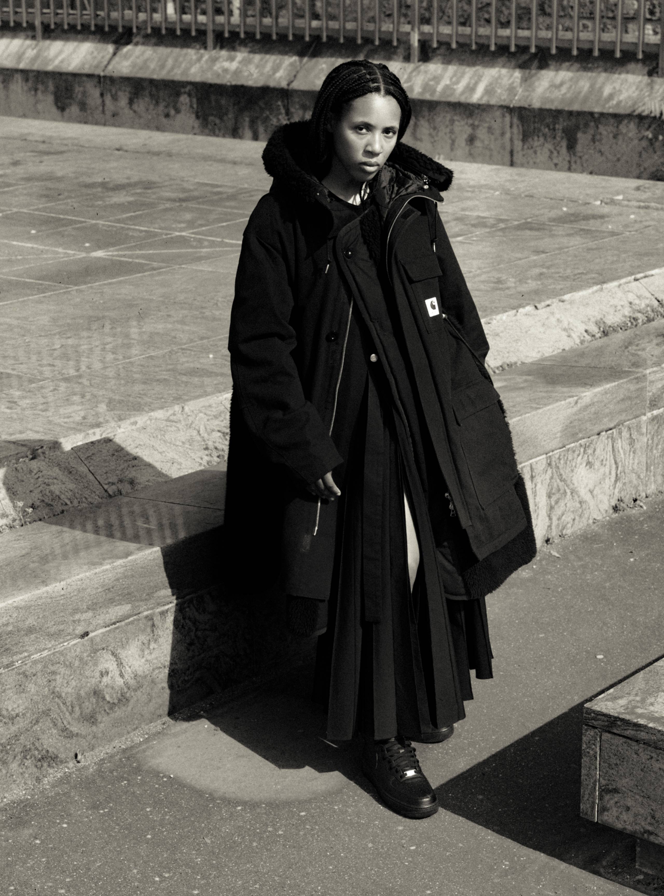 Model wearing items from the sacai x Carhartt WIP collection