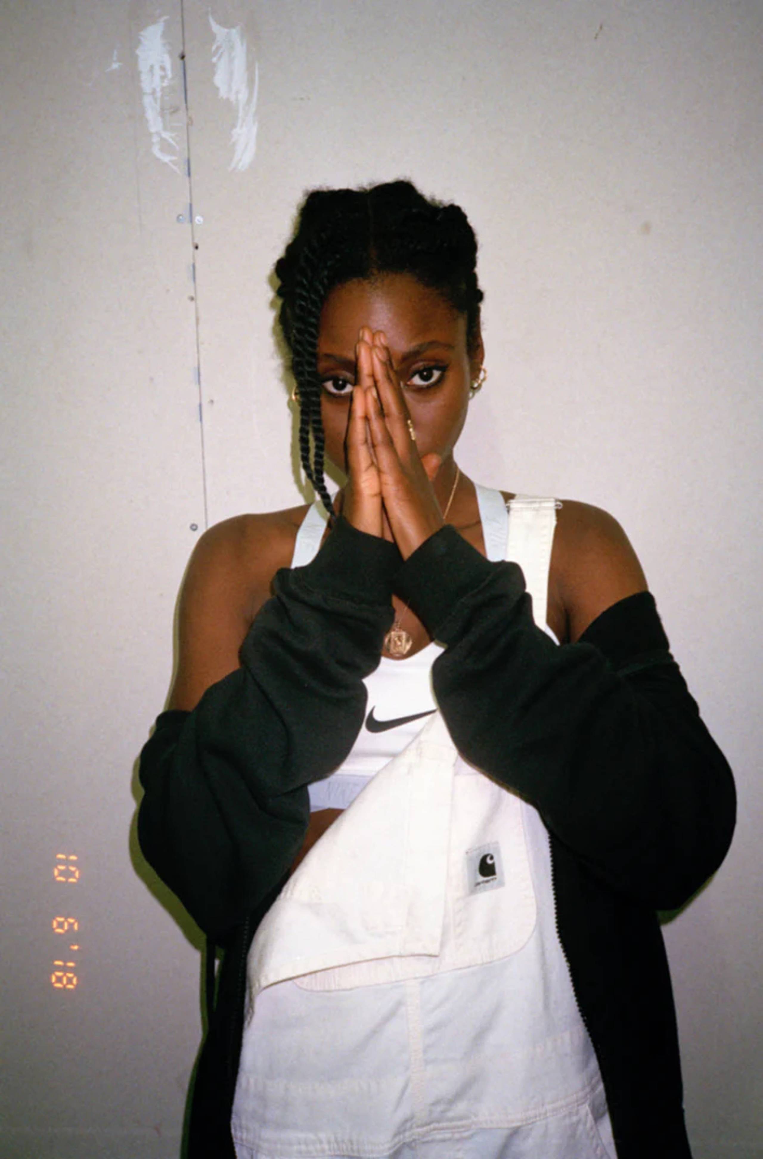 Model wearing white Carhartt WIP Overalls and Nike sports bra