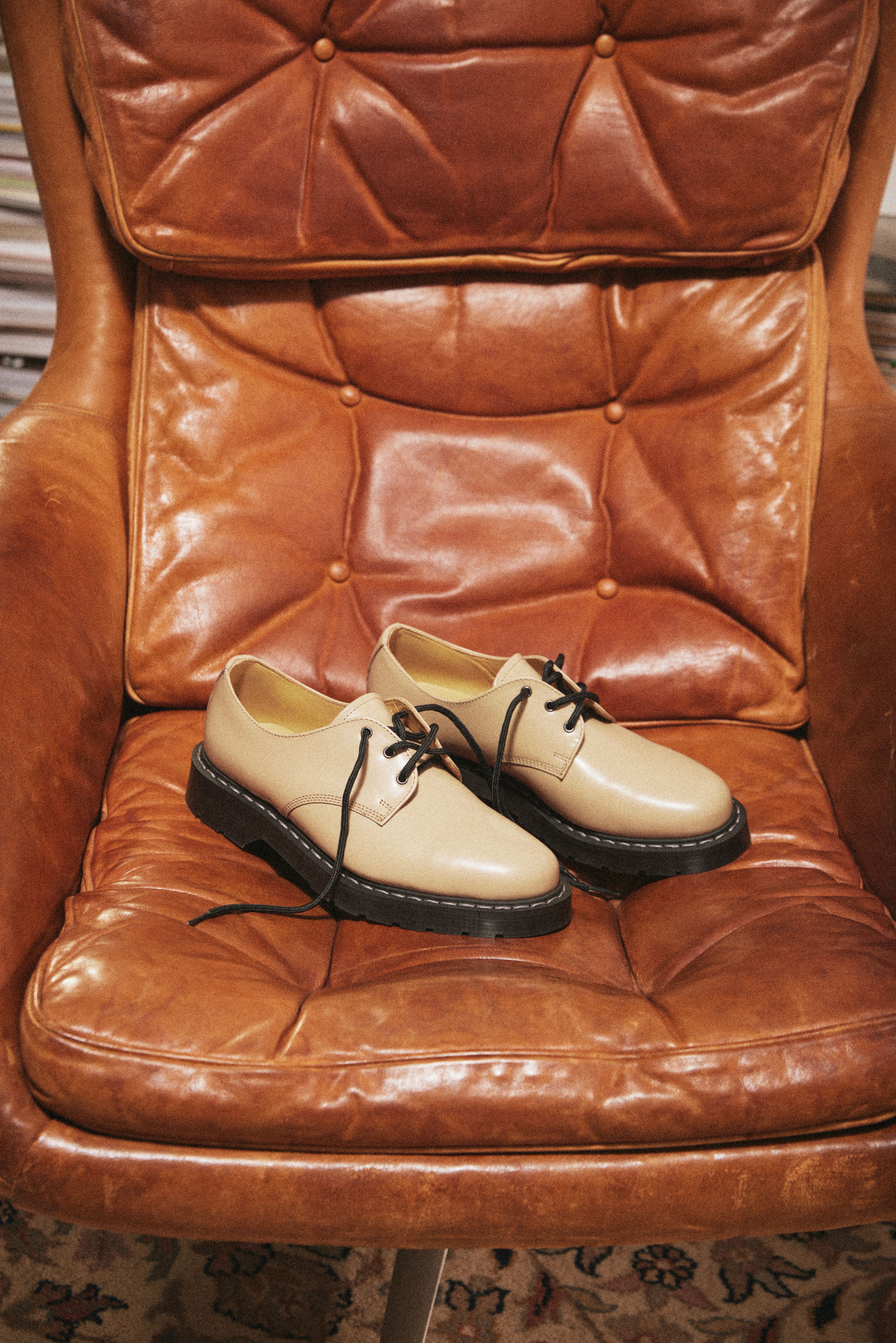 A pair of Solovair x Carhartt WIP Collaboration derbies on a leather chair