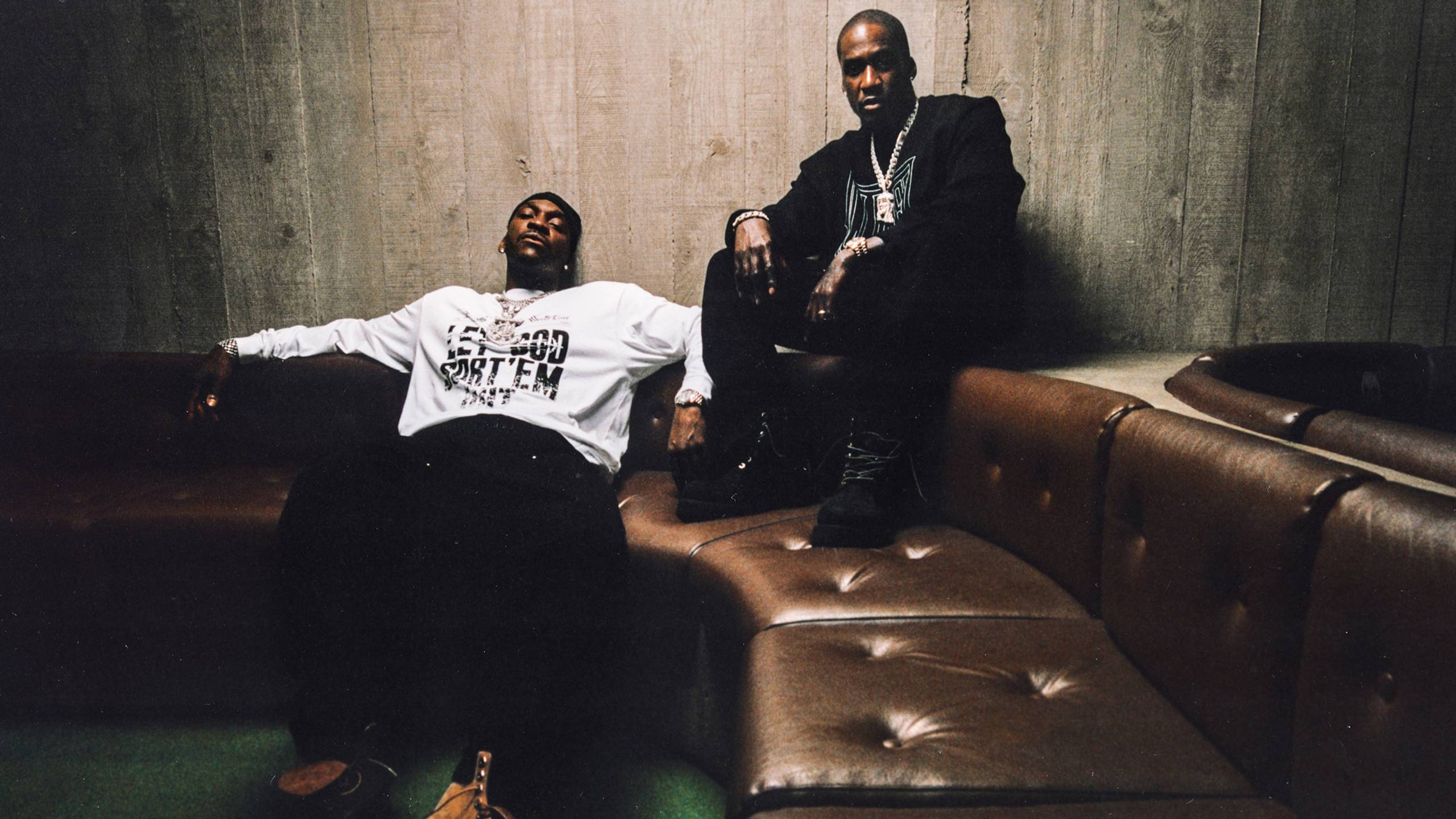 Artist Pusha T and Malice on a couch wearing items from the Carhartt WIP x CLIPSE collab