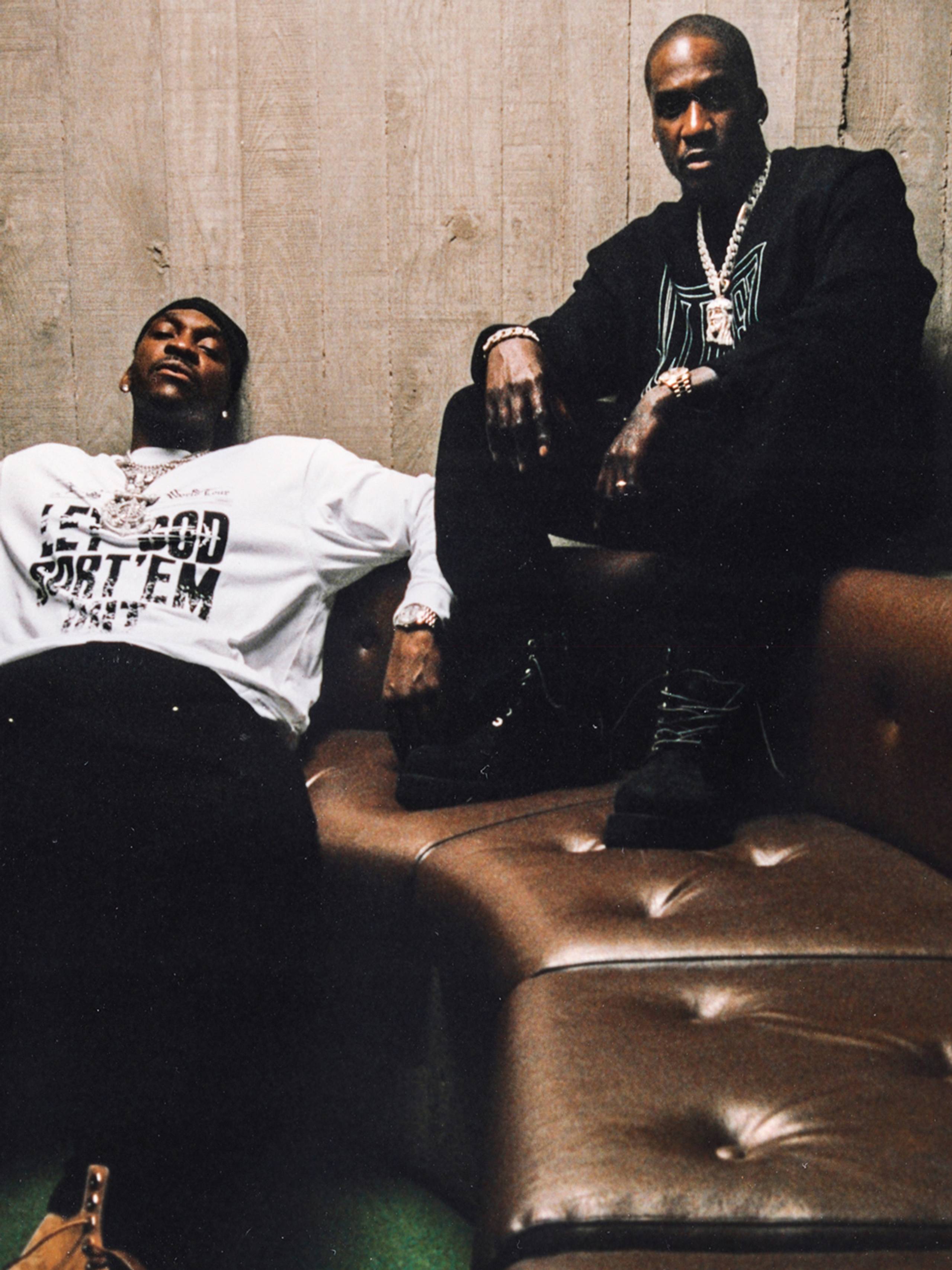 Artist Pusha T and Malice on a couch wearing items from the Carhartt WIP x CLIPSE collab