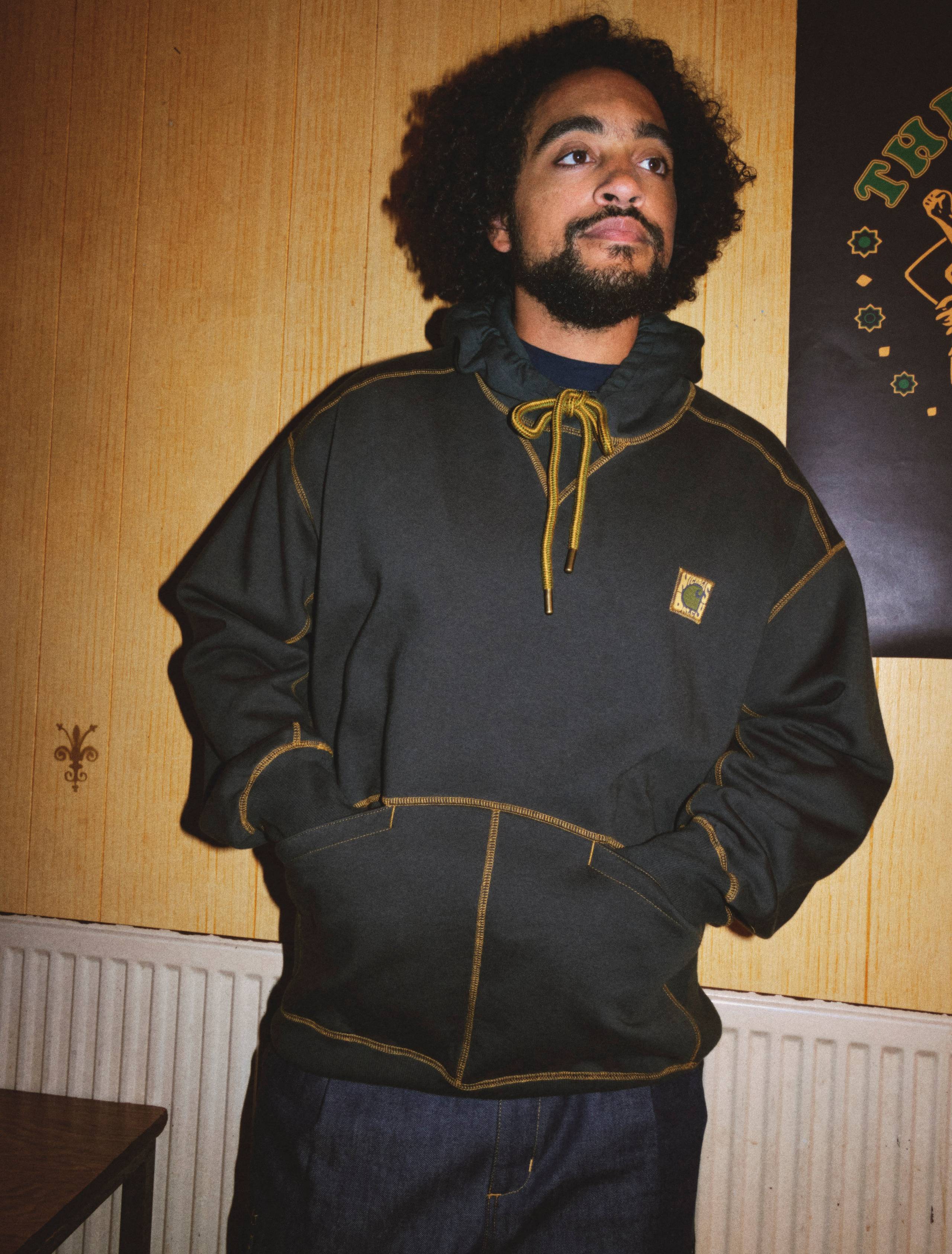 Model wearing a hooded sweatshirt from the Nicholas Daley x Carhartt WIP Collaboration