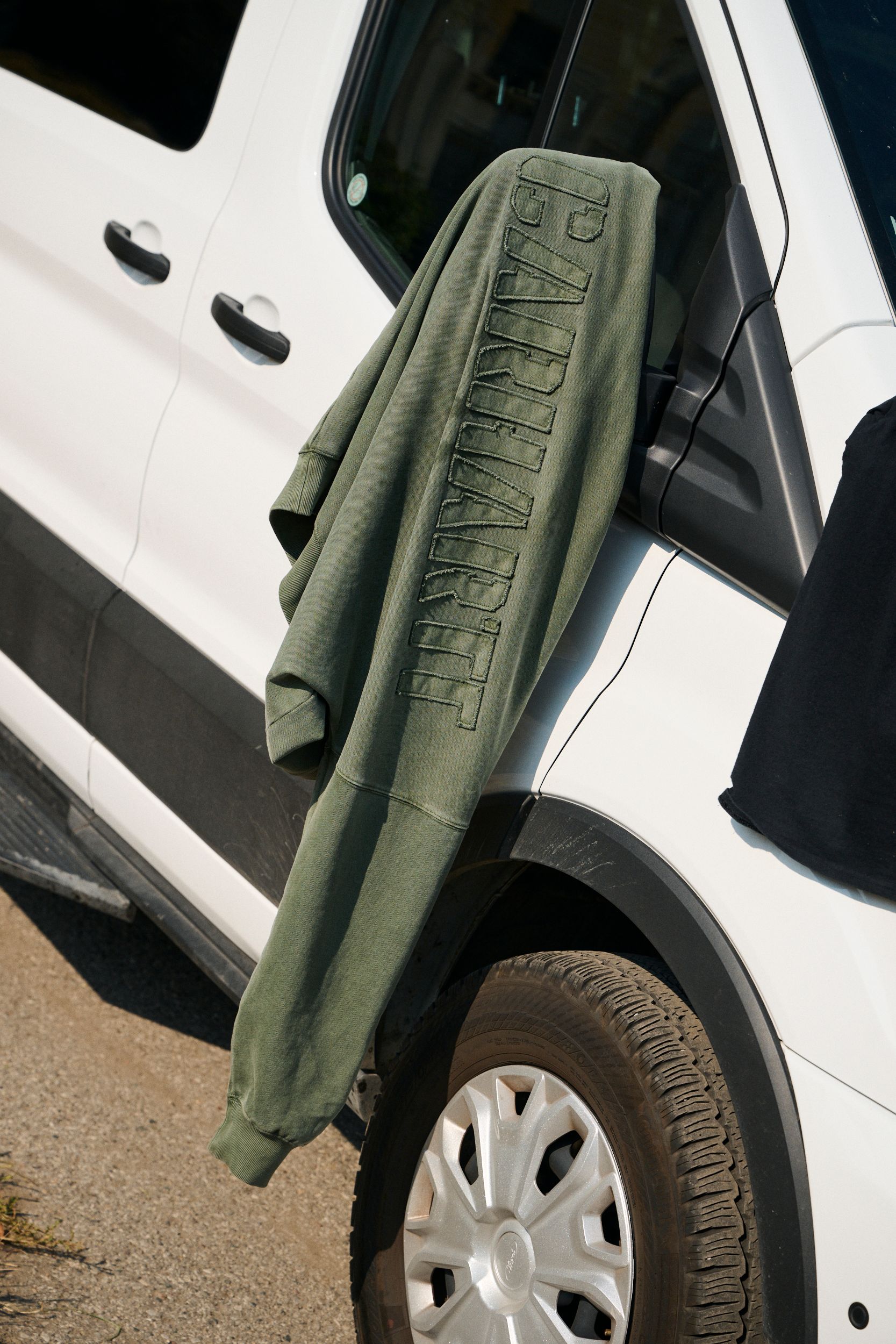 RGGD Sweatshirt hanging on a Van rearview mirror