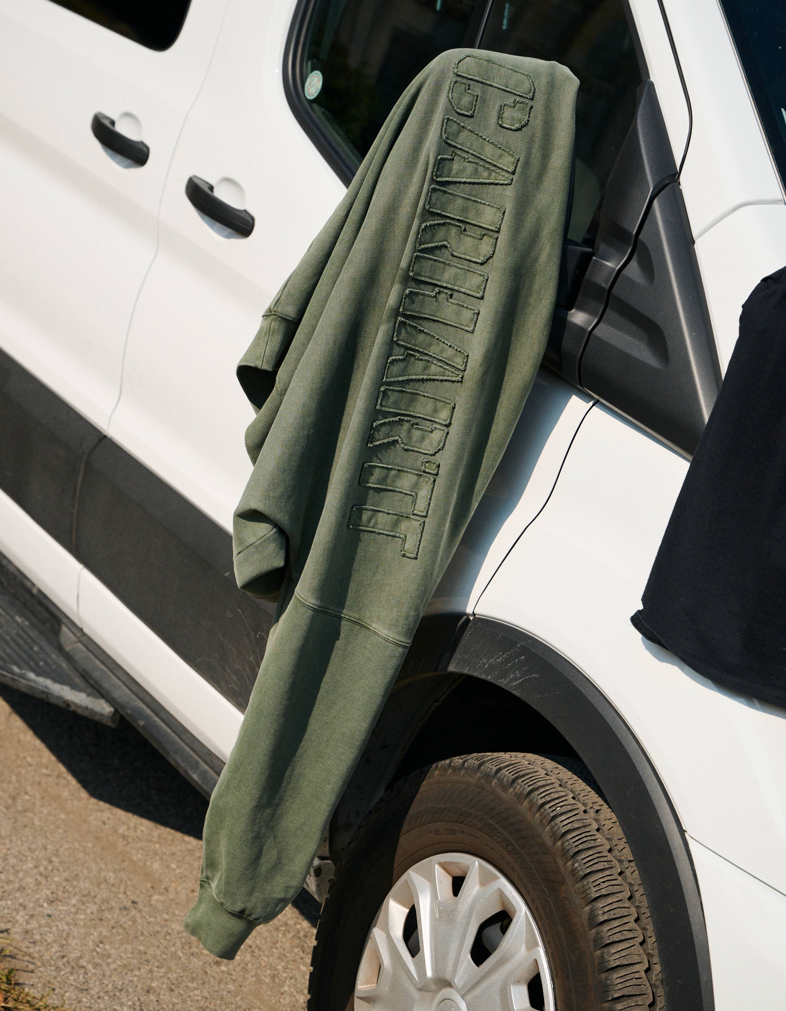 RGGD Sweatshirt hanging on a Van rearview mirror