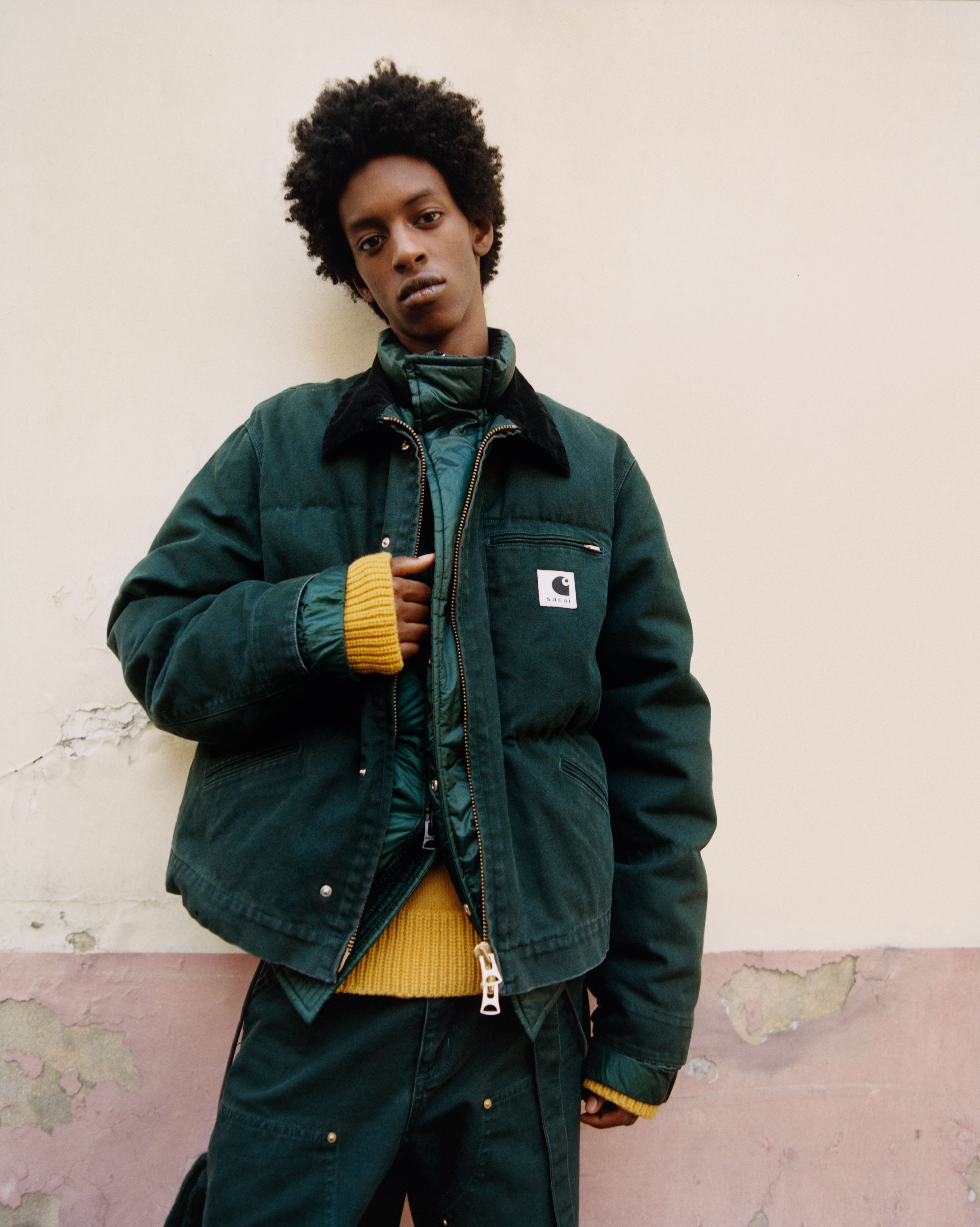 Model wearing a sacai x Carhartt WIP jacket and pants