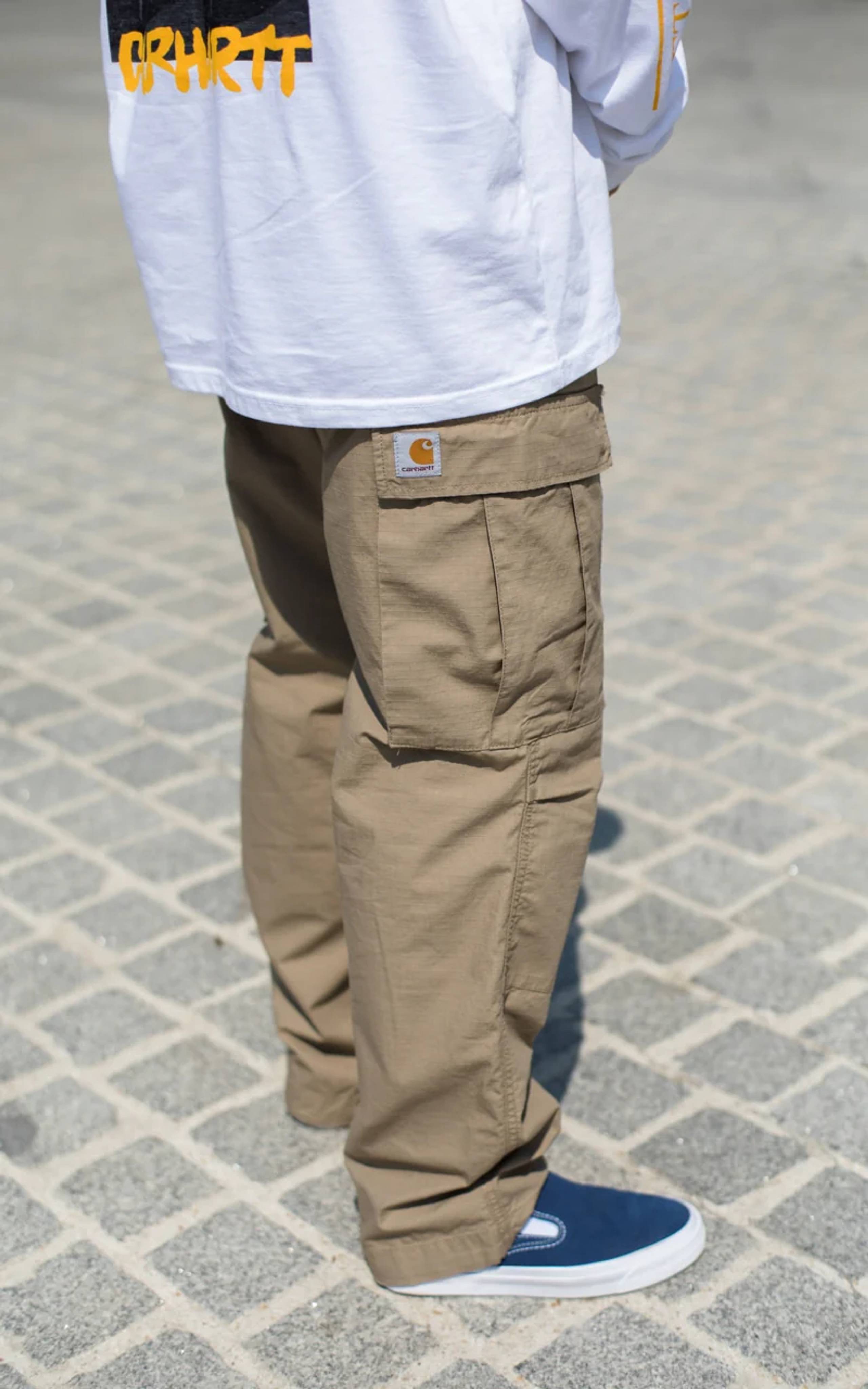 Model wearing tan Carhartt WIP cargo pants