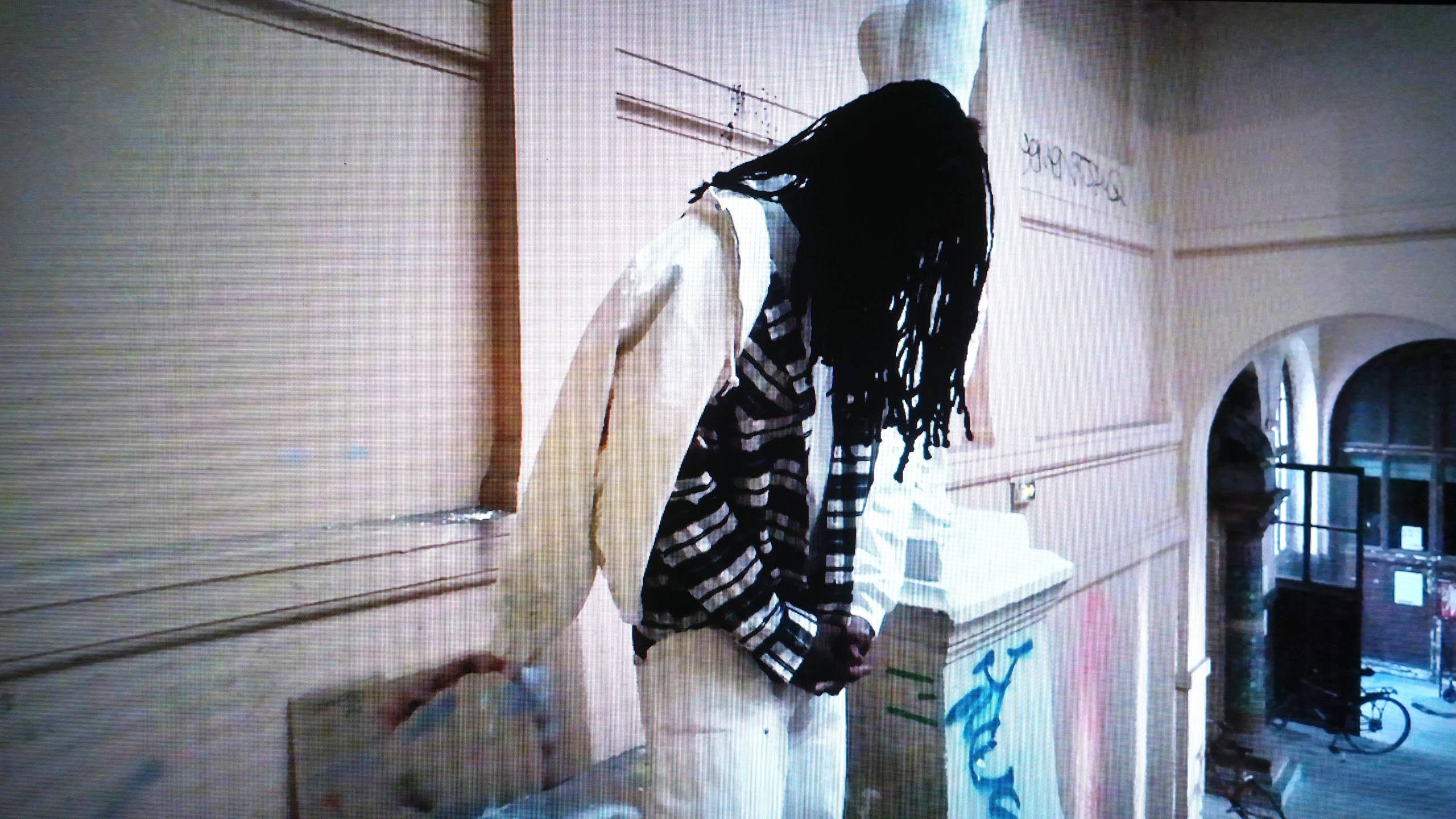 Person wearing a white jacket and white pants