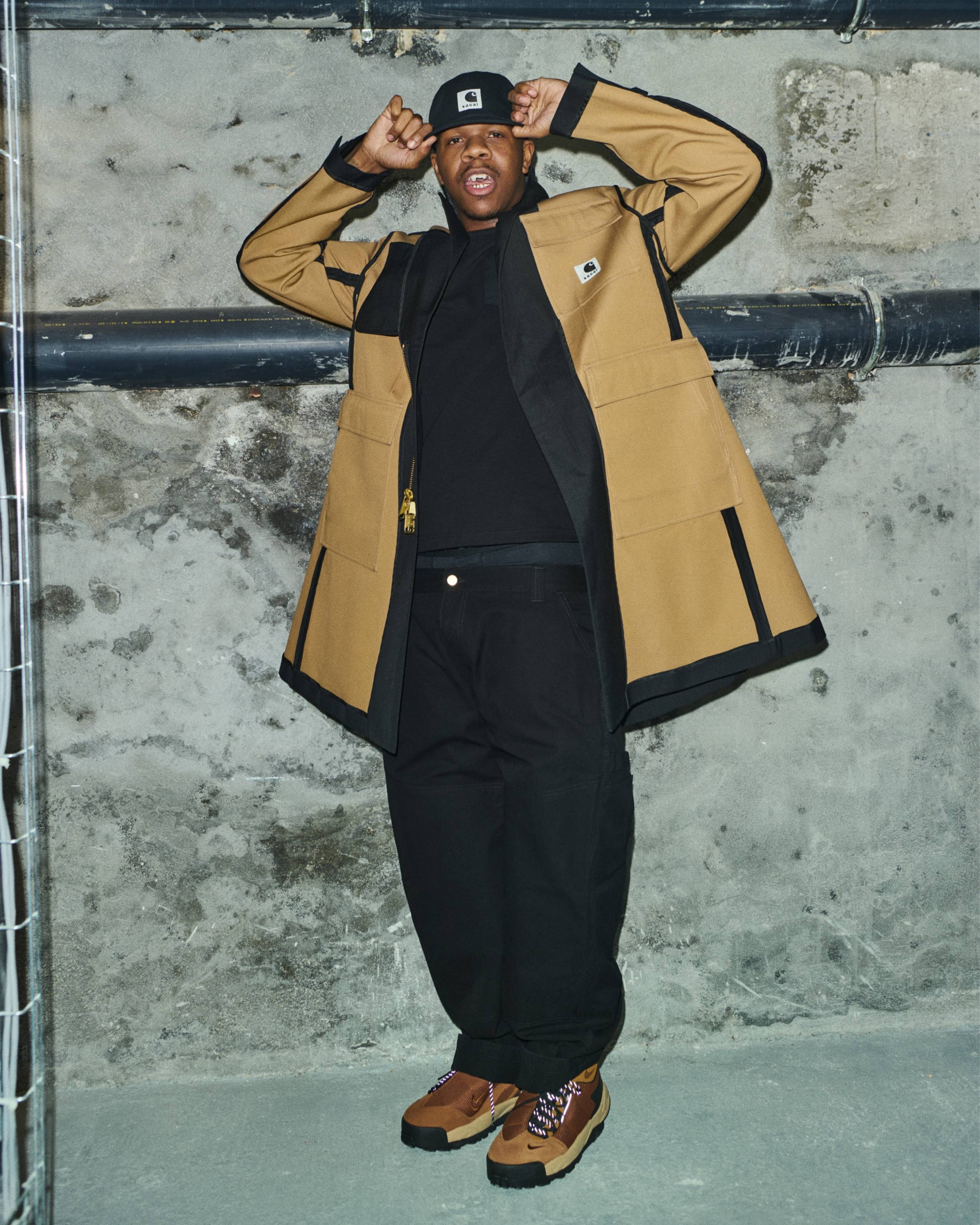 HiTech wearing items from the sacai x Carhartt WIP Collaboration