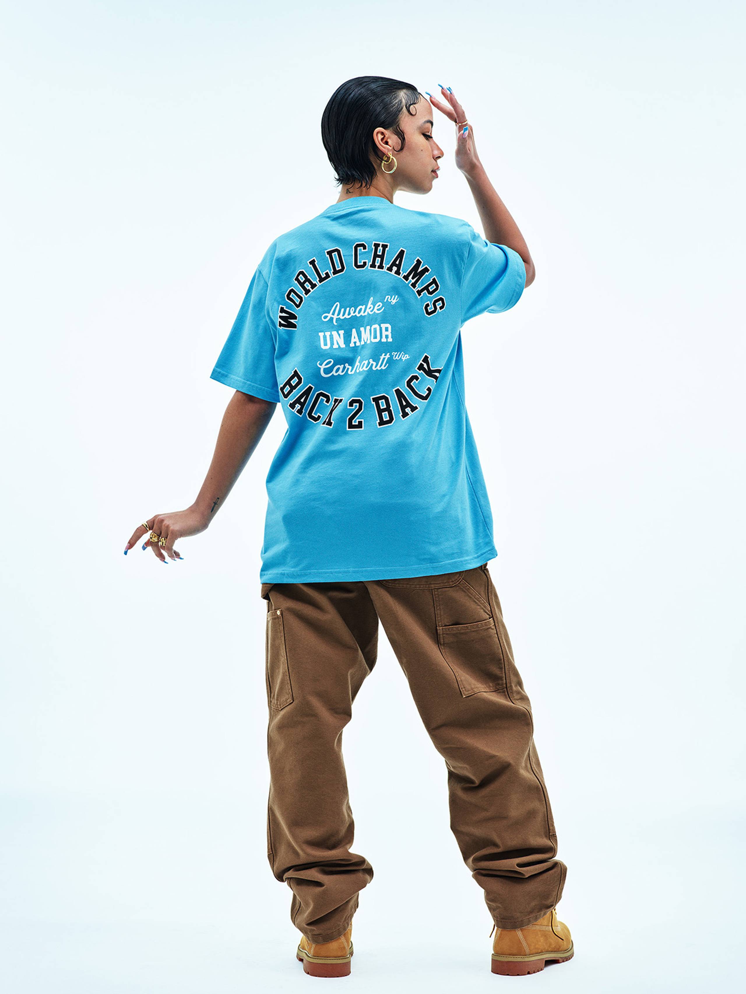 Model wearing Carhartt WIP x Awake NY pocket t-shirt in Blue