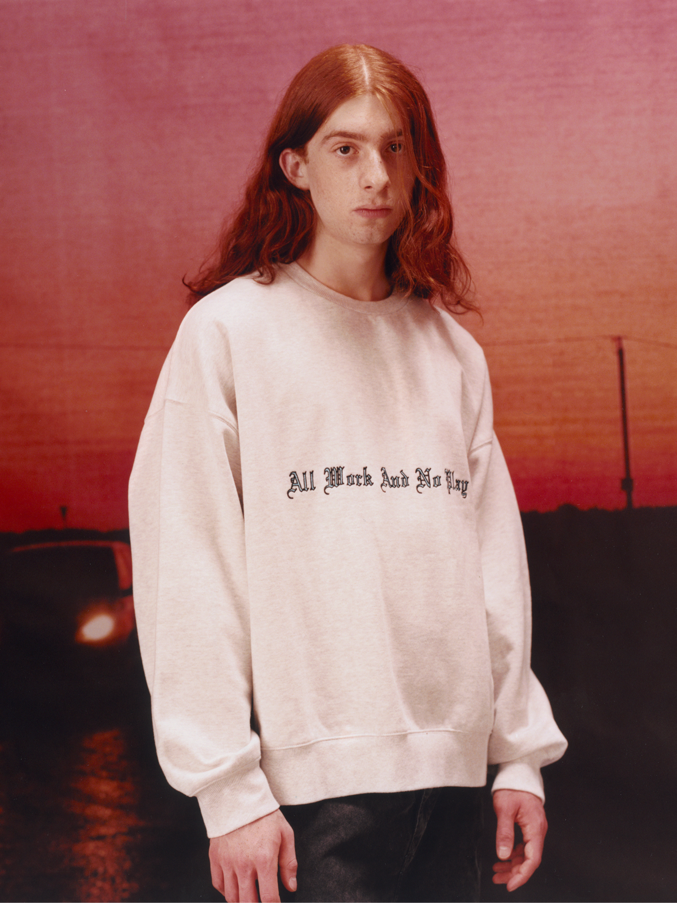Model wearing a script graphic sweatshirt in the Carhartt WIP F/W25 Men's Lookbook