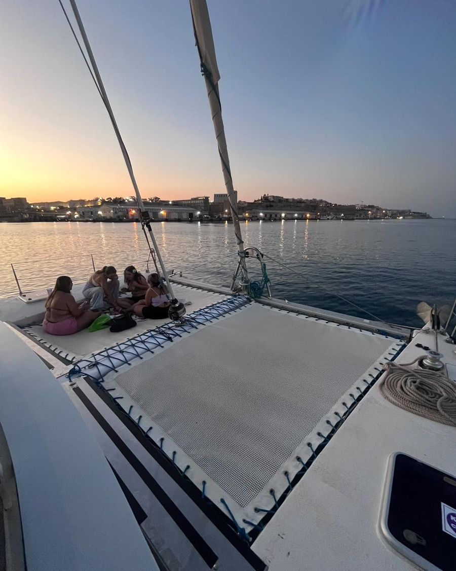 Sunset over the sea from the deck of a Catamaran Malta charter.