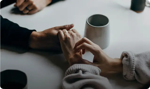 A married couple holds hands