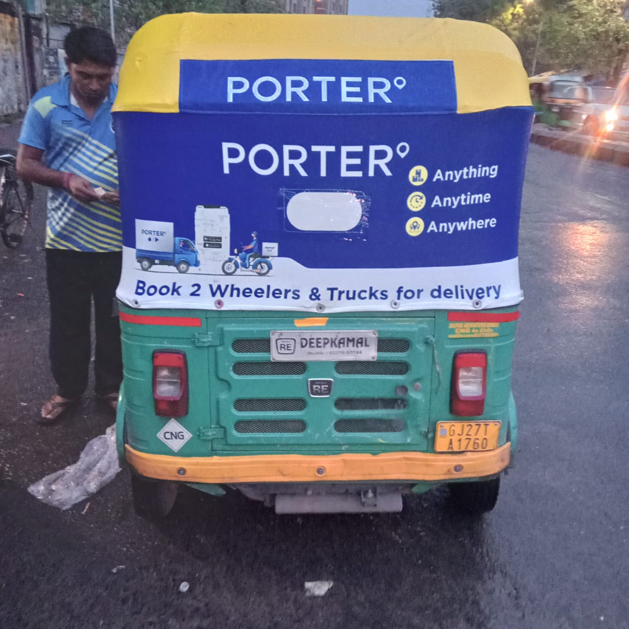 Branded shared auto rickshaw with Bengali-language hood advertising on a fixed route through the Gariahat market corridor in Kolkata