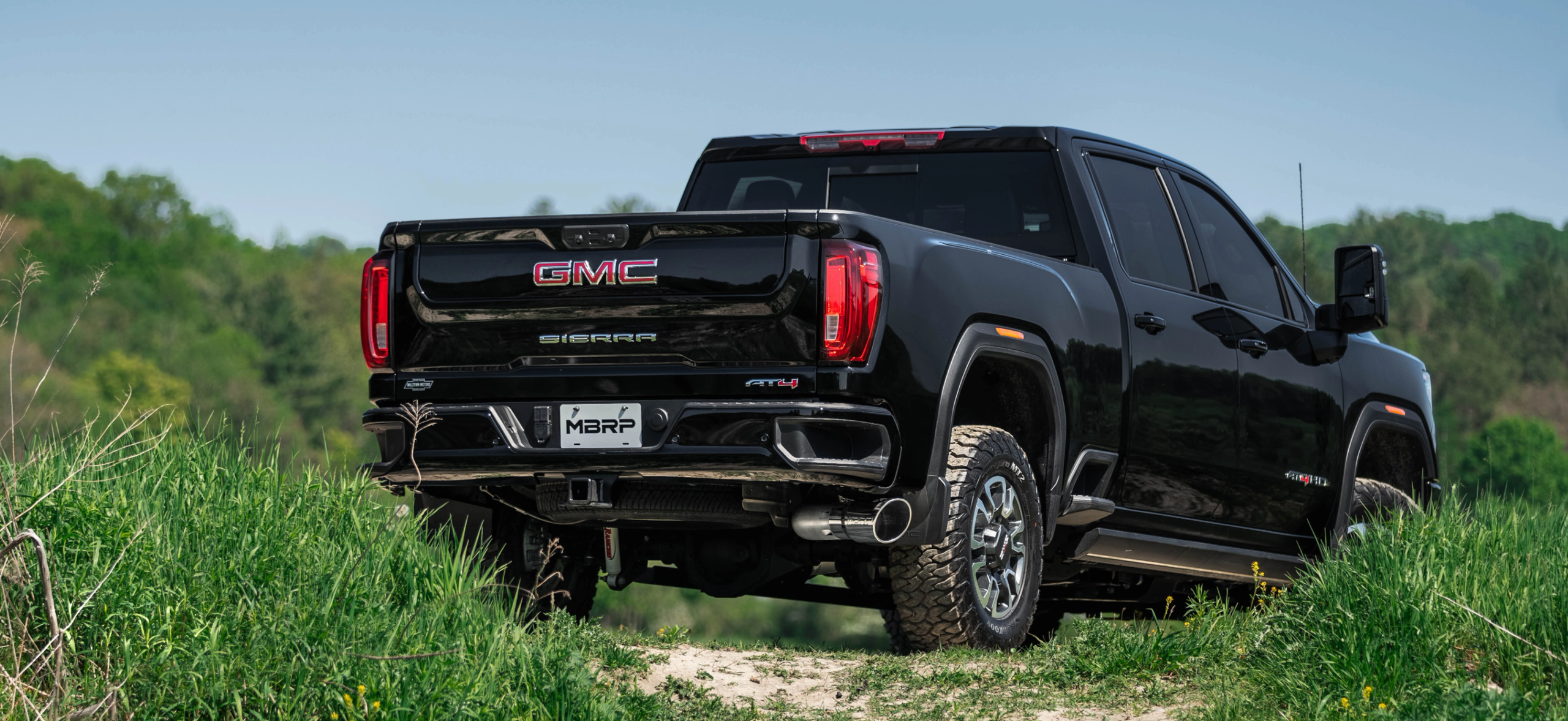 Black GMC Sierra in a field showing an mbrp exhaust system installed