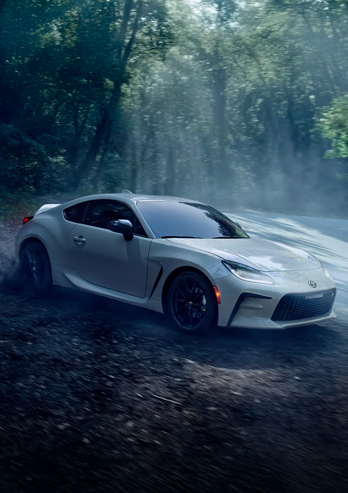 White Toyota GR86 driving through the trees