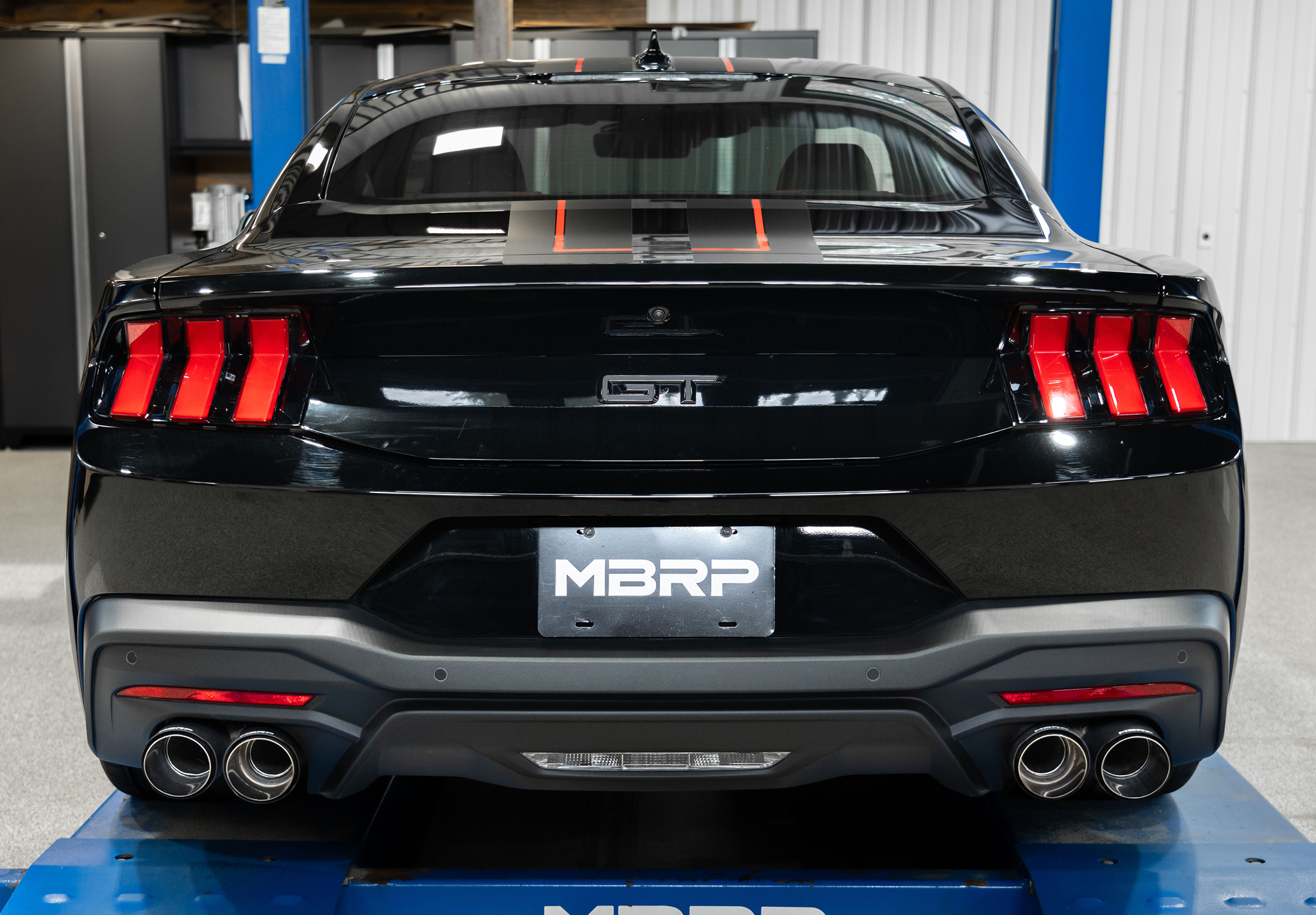 Black Ford GT Mustang on the hoist that just had an mbrp exhaust installed