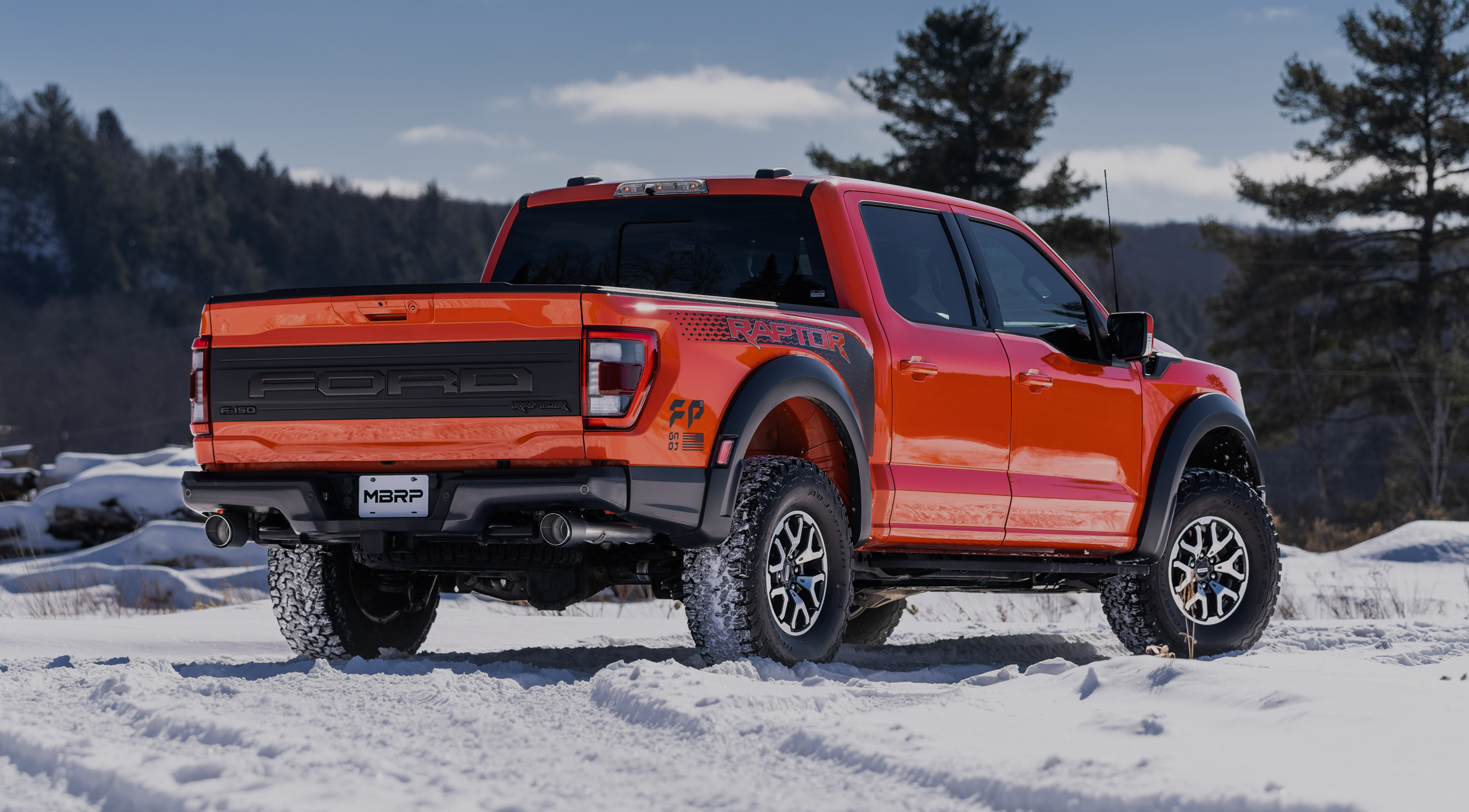 Ford raptor in the snow with an mbrp exhaust