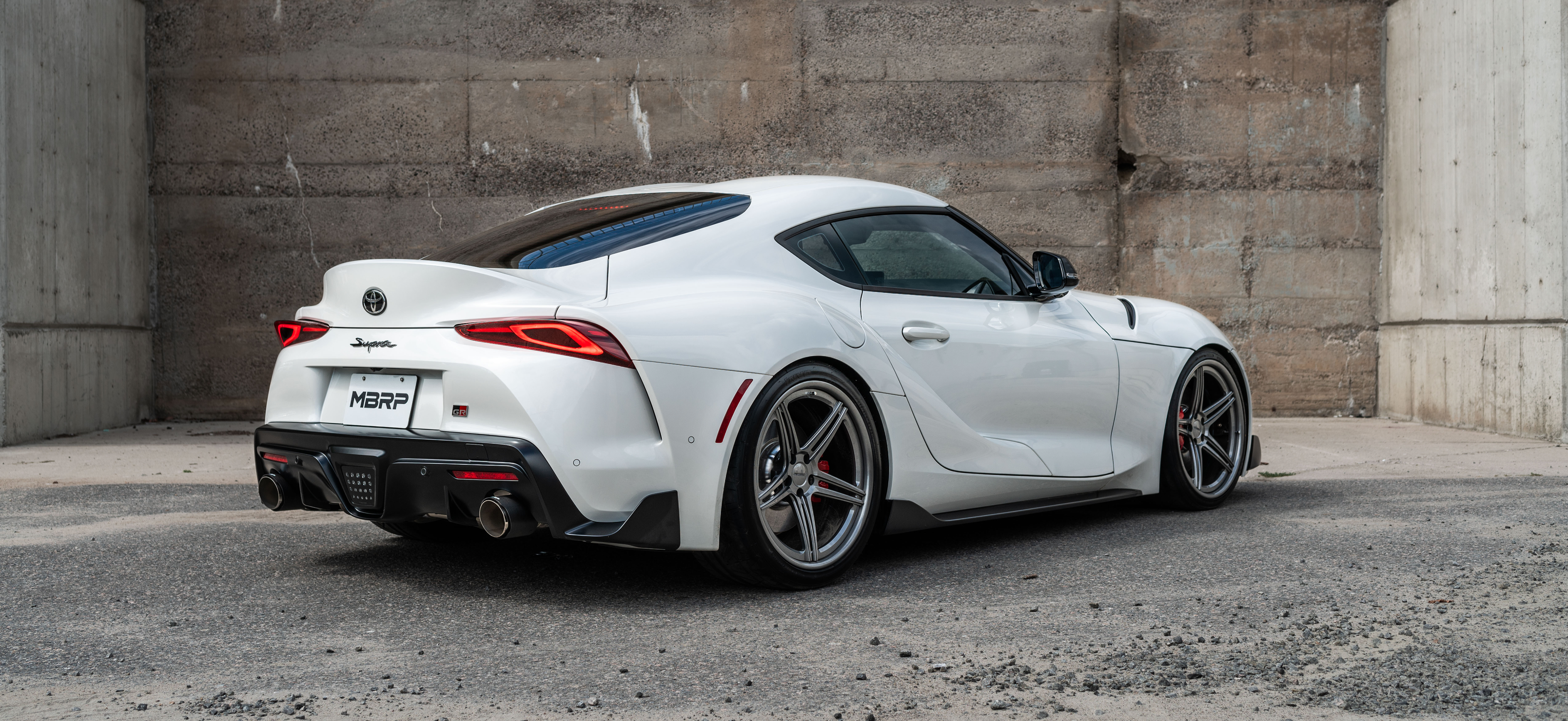 White Supra with an mbrp exhaust