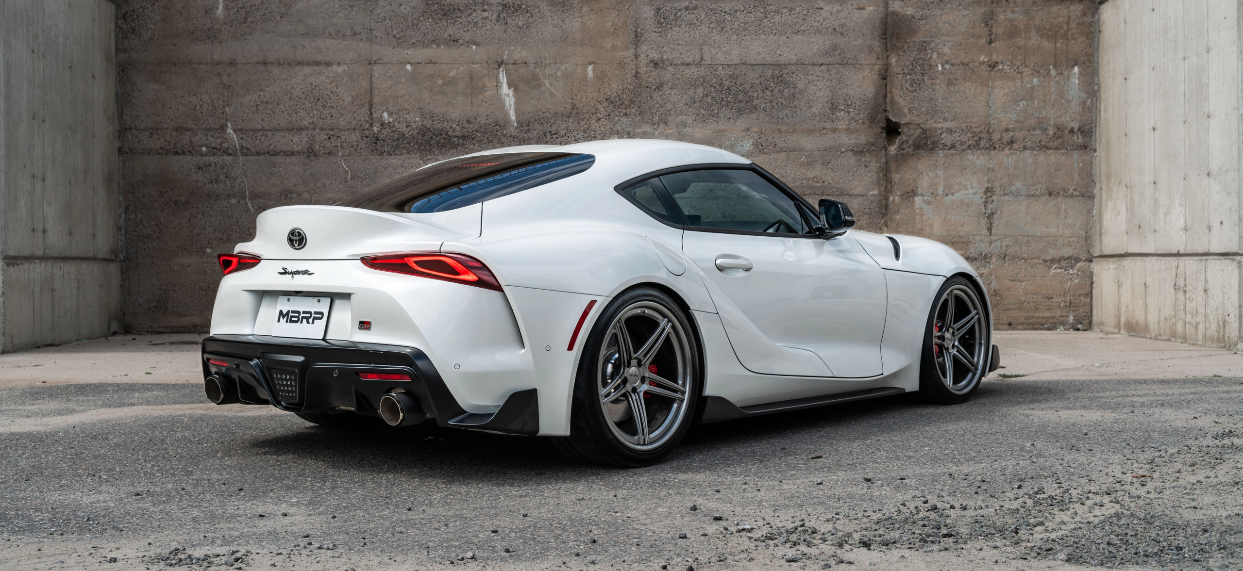 White Supra with an mbrp exhaust
