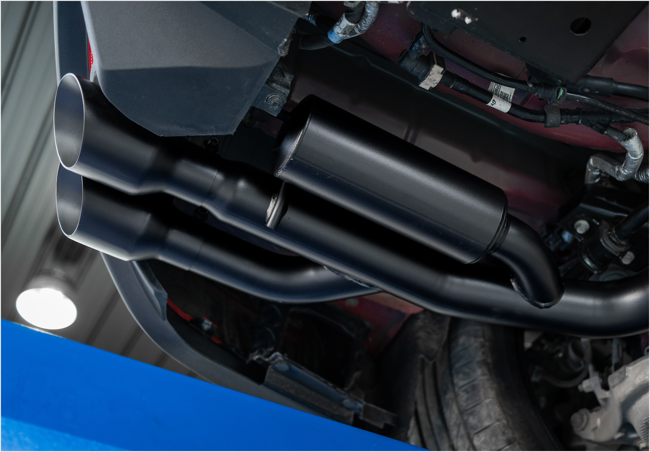 MBRP blk coated material on an exhaust installed on a vehicle
