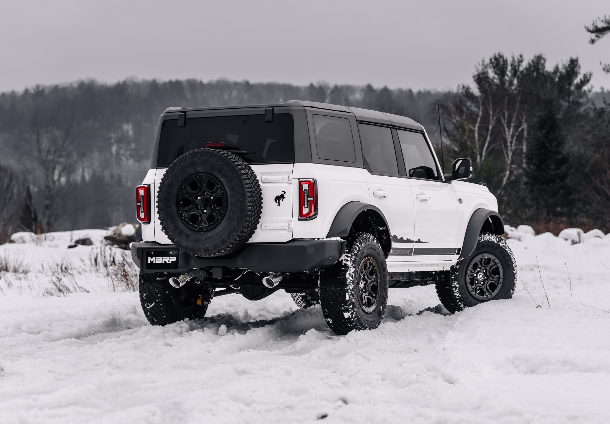 White Ford Bronco in the winter with an mbrp exhaust installed