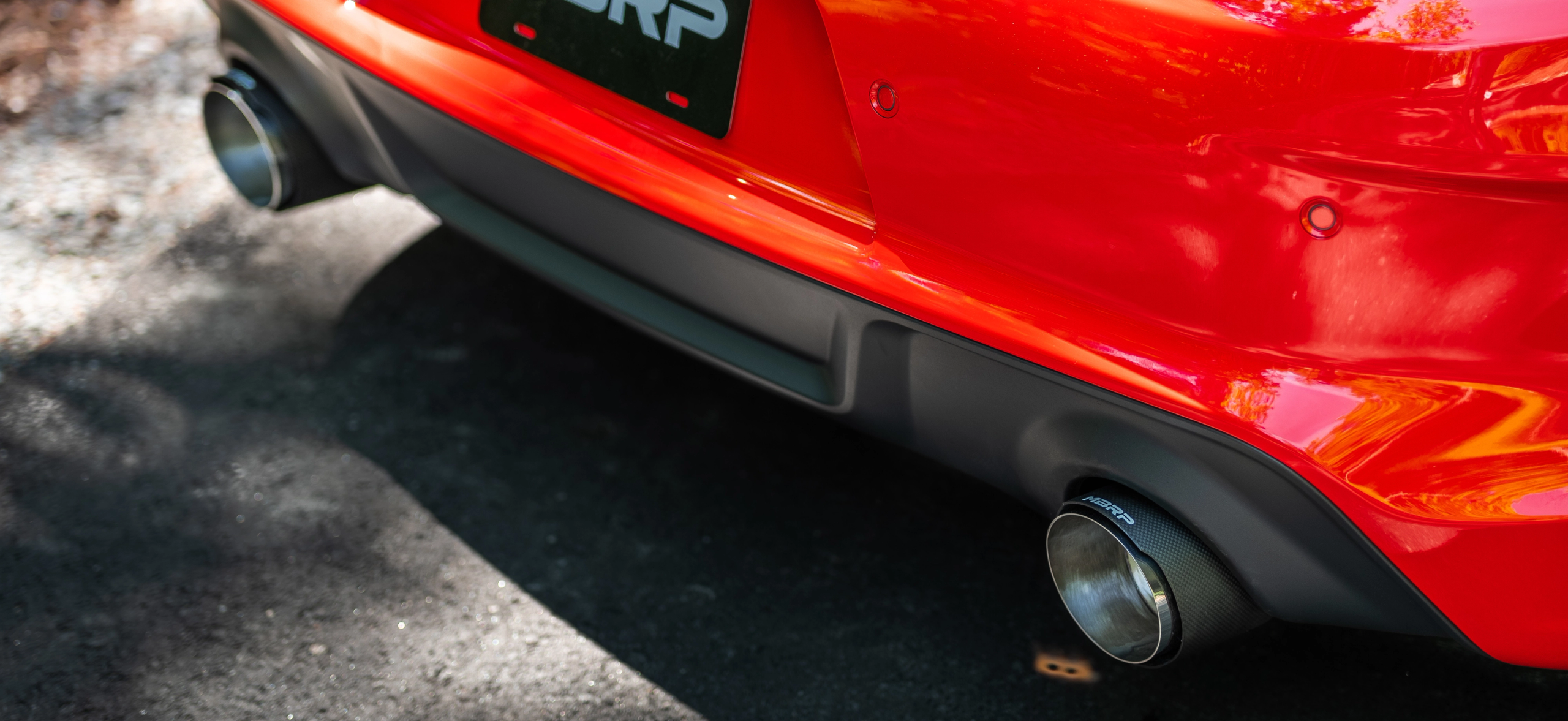 Red car showing mbrp carbon fiber exhaust tips