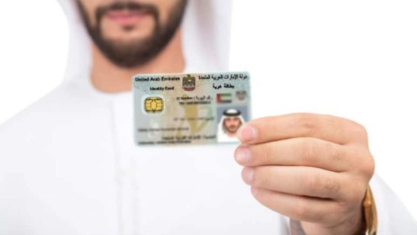 Consultant in Abu Dhabi assisting a client with Emirates ID Typing on a computer