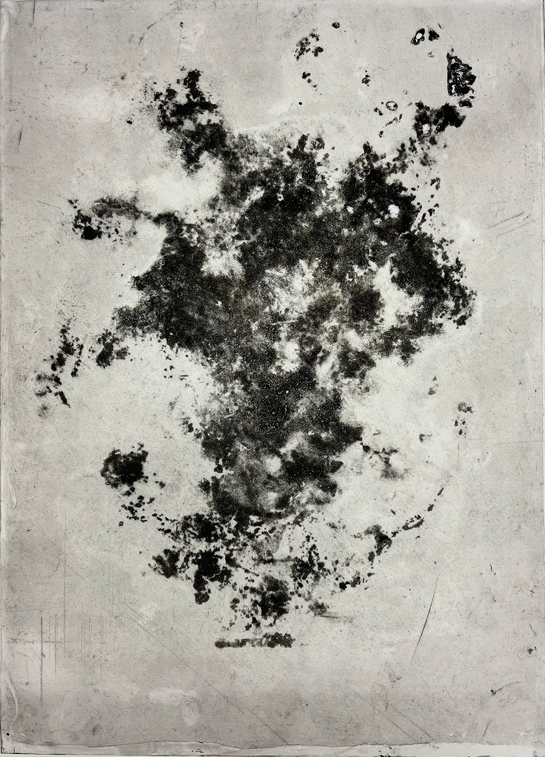 A grey metal plate with the same abstract, organic-looking, brownish motif imprinted on it