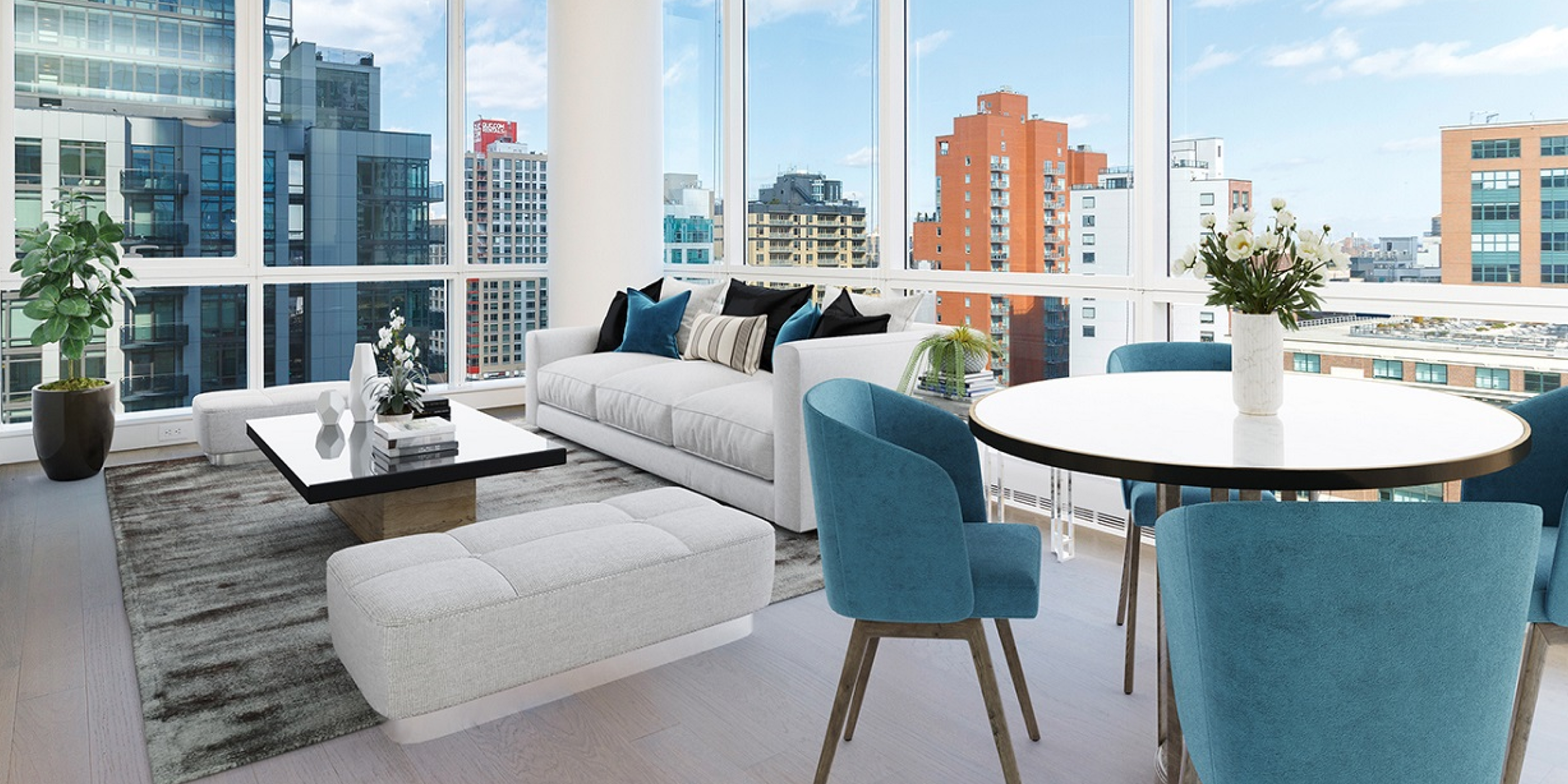 Living room area with couch, coffee table, and view of the city