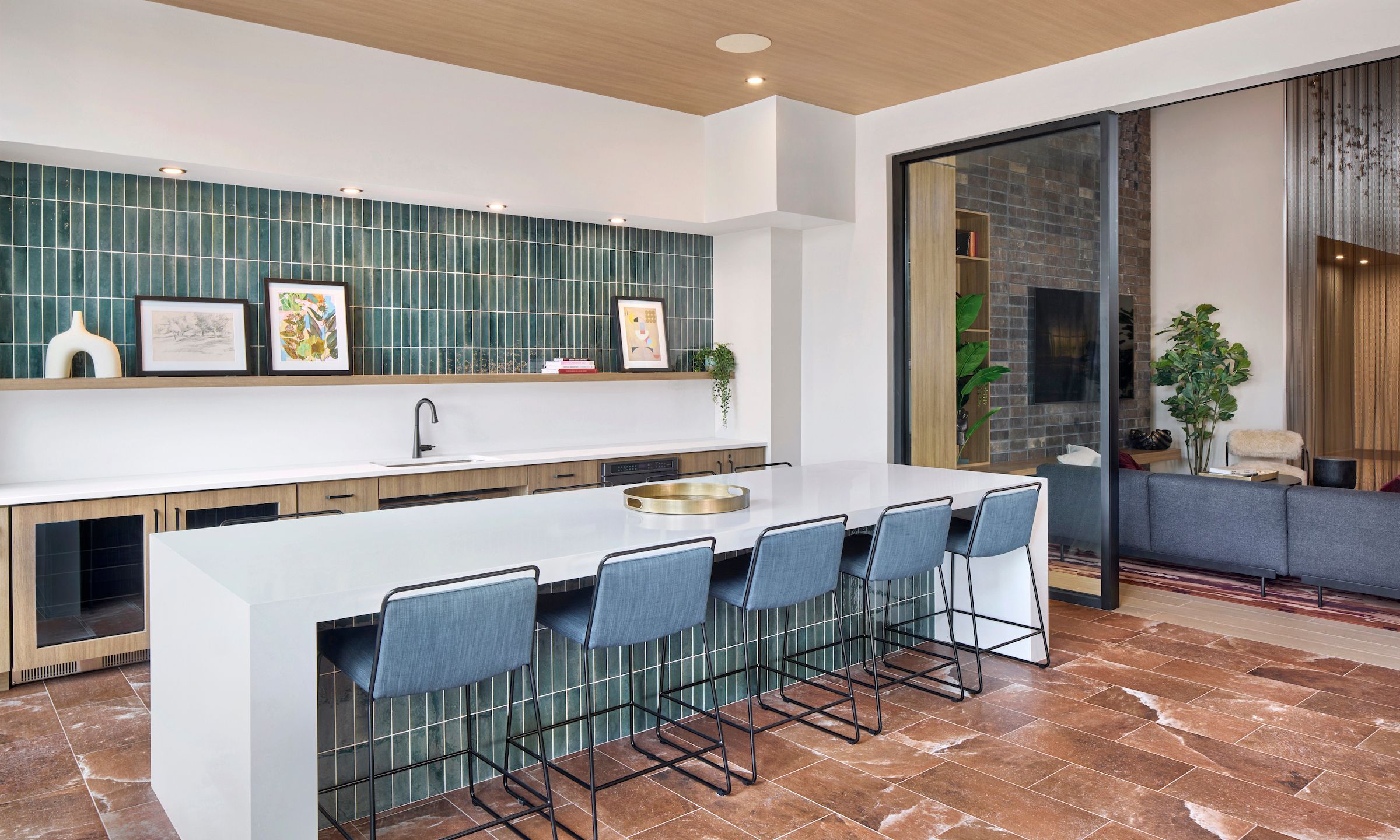 Contemporary lounge with TV, modern decor, cozy seating, and people enjoying conversations.