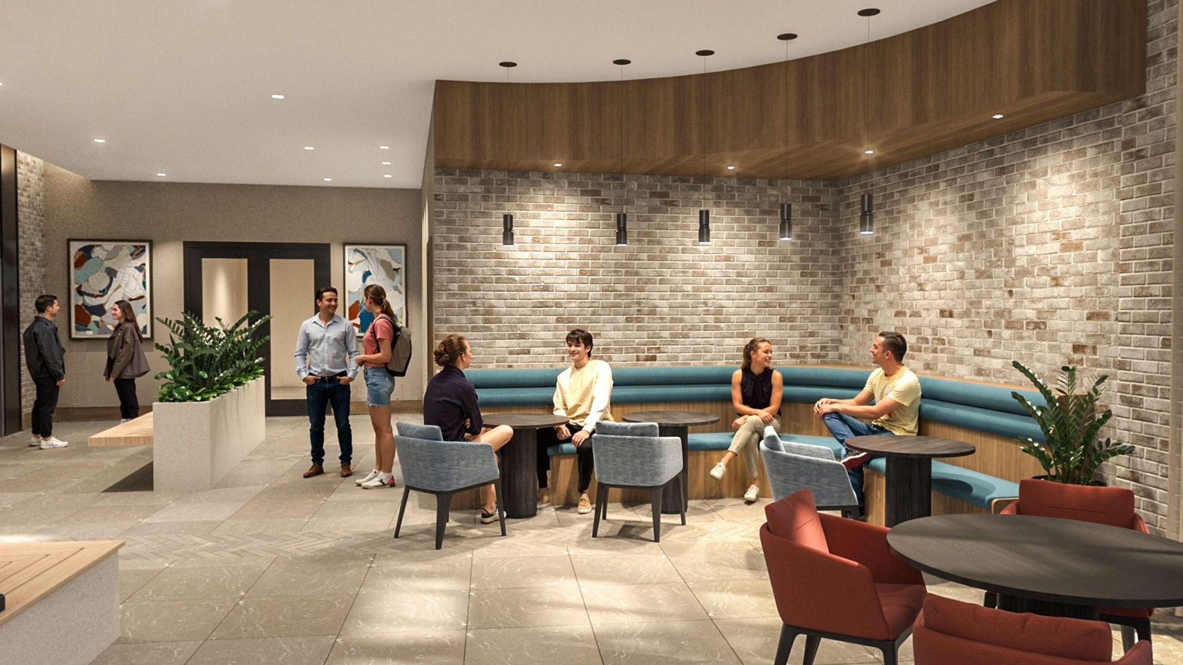 Modern lounge area with brick walls, curved seating, and people chatting in a relaxed setting.