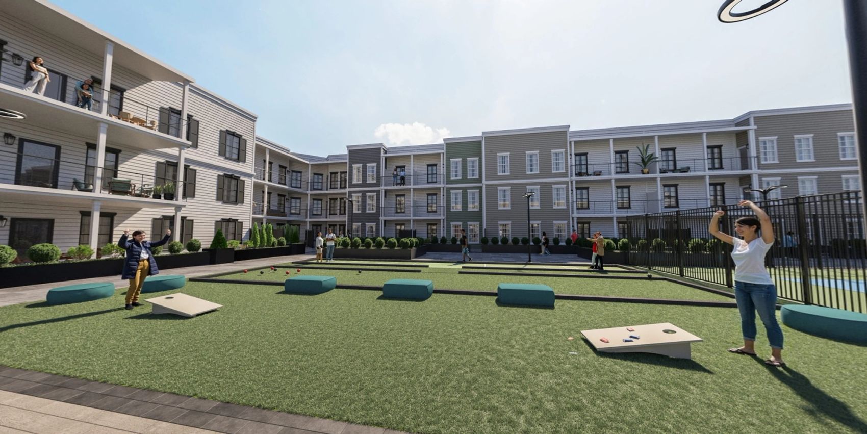 Quad courtyard with people playing games and relaxing near three-story residential buildings.