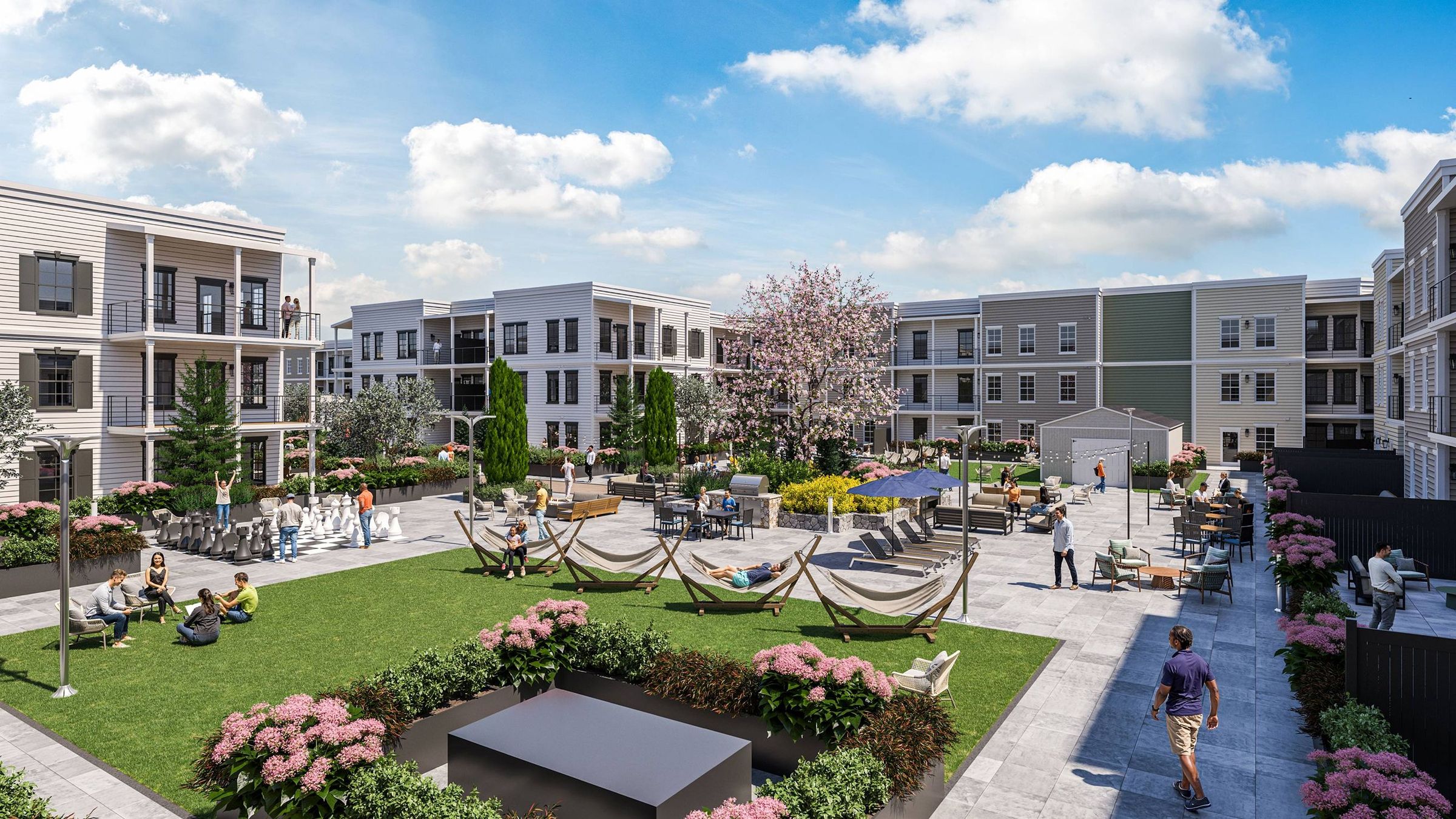 Outdoor courtyard with hammocks, giant chess, seating areas, and people enjoying leisure time.