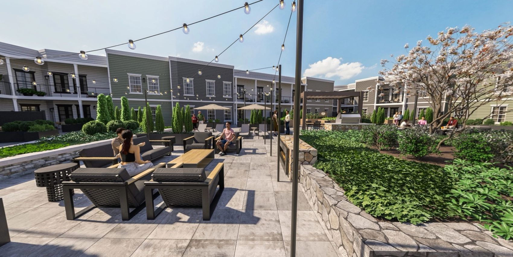 Gather year-round around The Fireside Lounge — a cozy outdoor retreat with plush seating, a warming fireplace, ambient hanging lights, and a coffee table perfect for conversations or relaxing evenings under the stars.