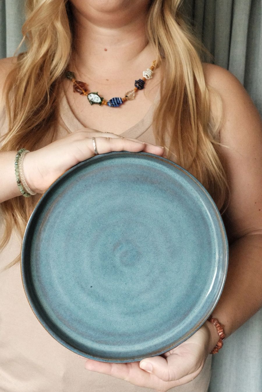 A large blue speckled dinner plate held in both hands