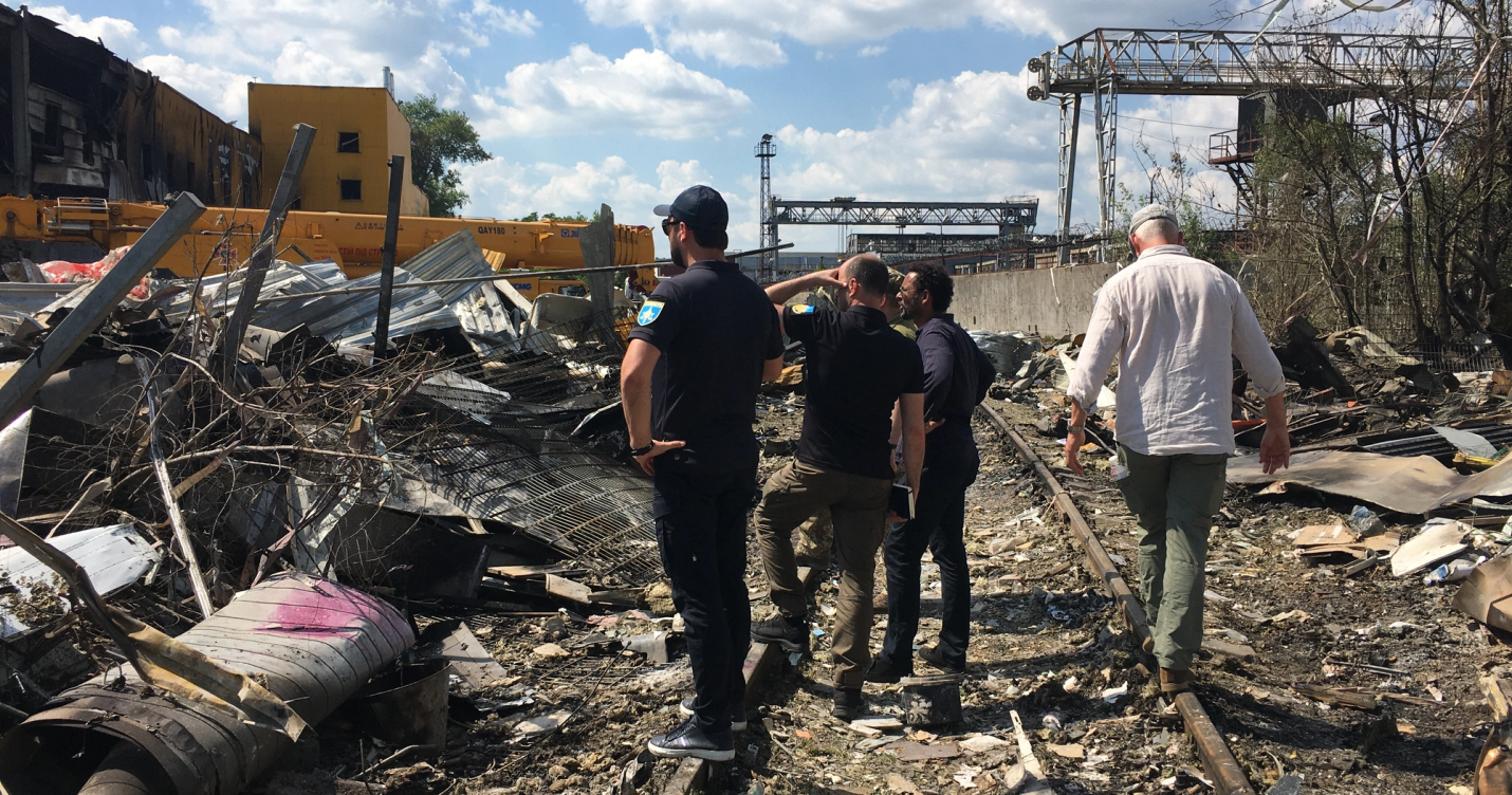 Men inspecting an area of the city in Ukraine that has been devastated by war.