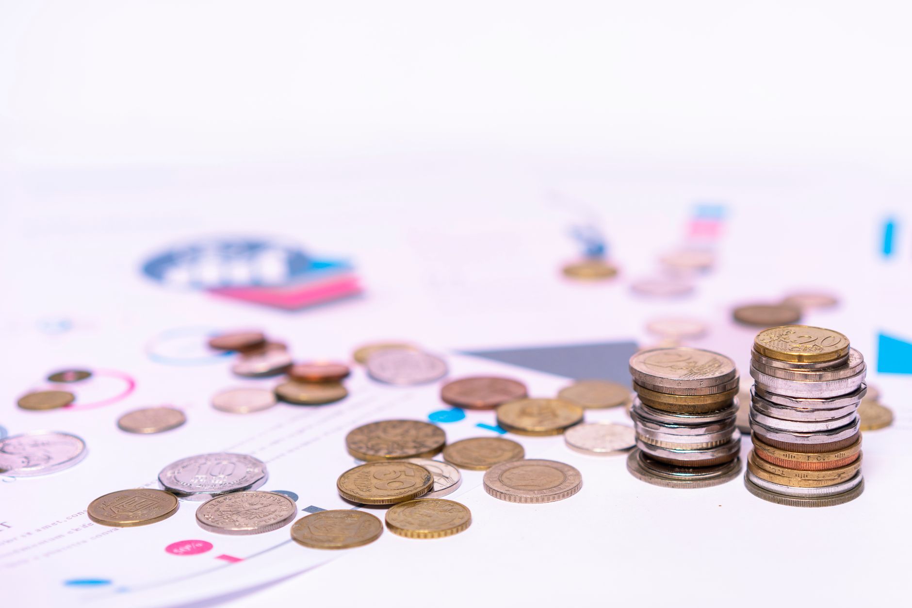 Stacks of coins scattered across a printed chart