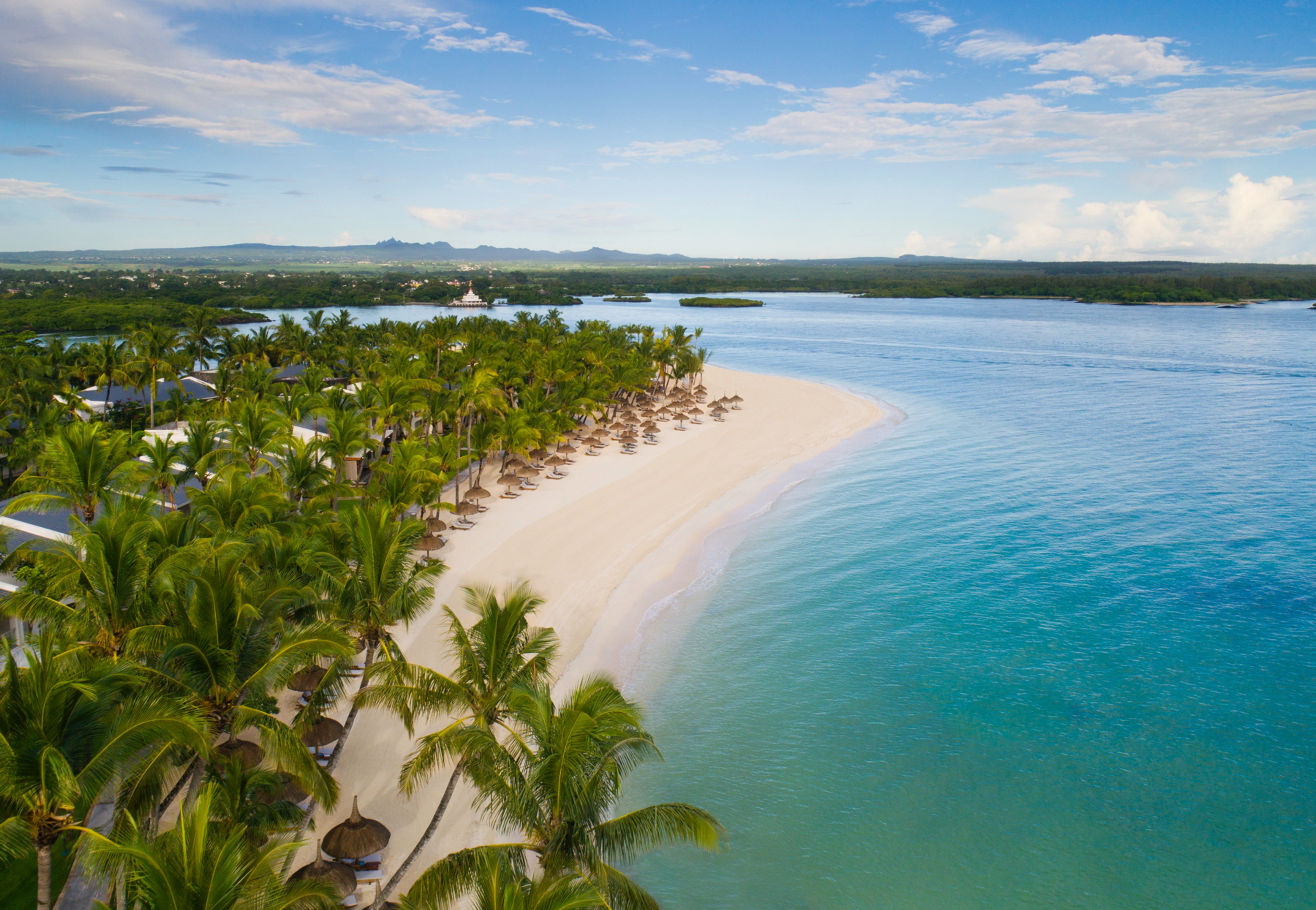 Bird's Eye View of Beachfront with Umbrellas and Shoreline down Coast of Mauritius