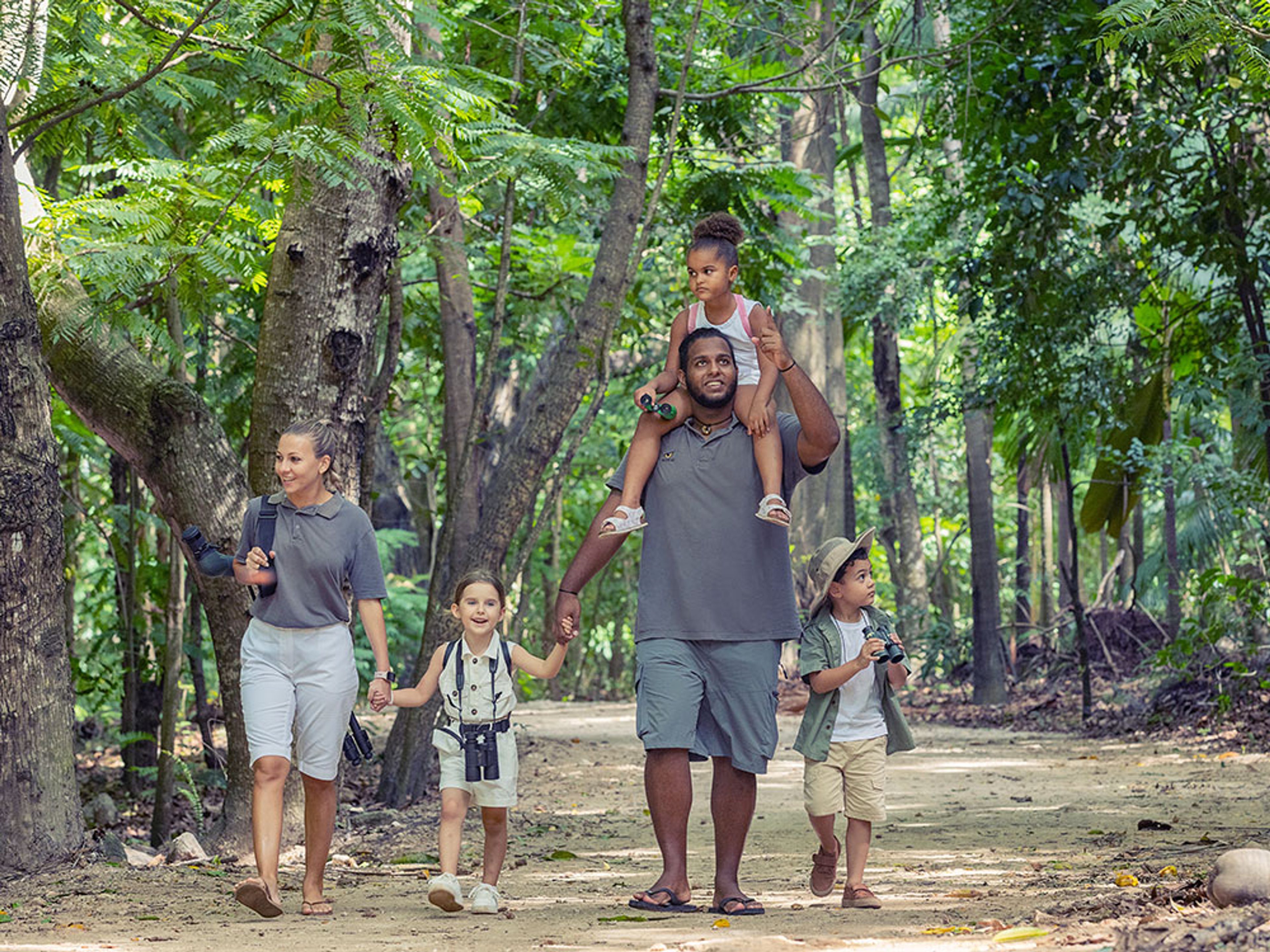 Family hiking through a forested trail