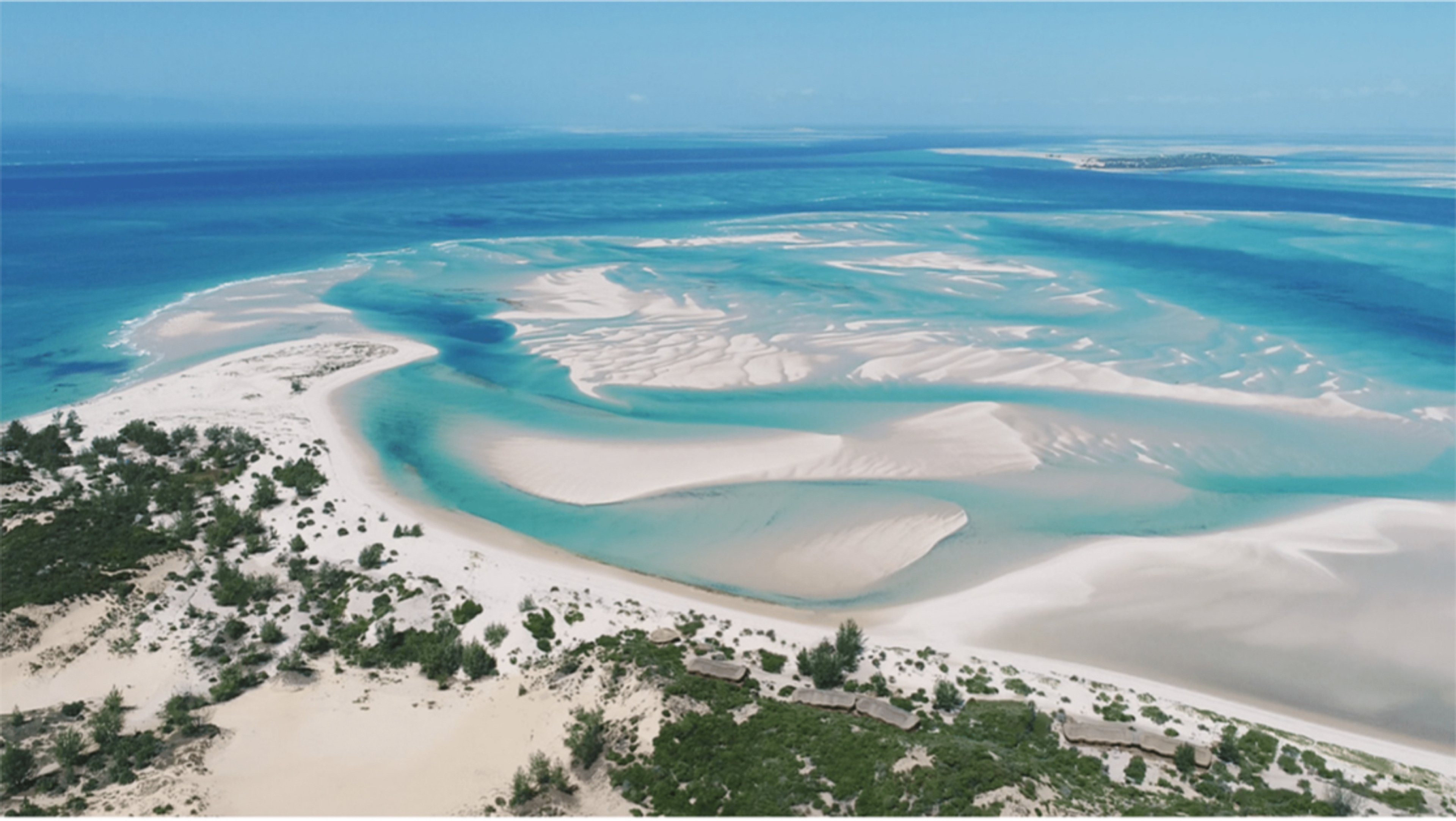 Aerial view of a coastal landscape with white sandbanks and turquoise waters